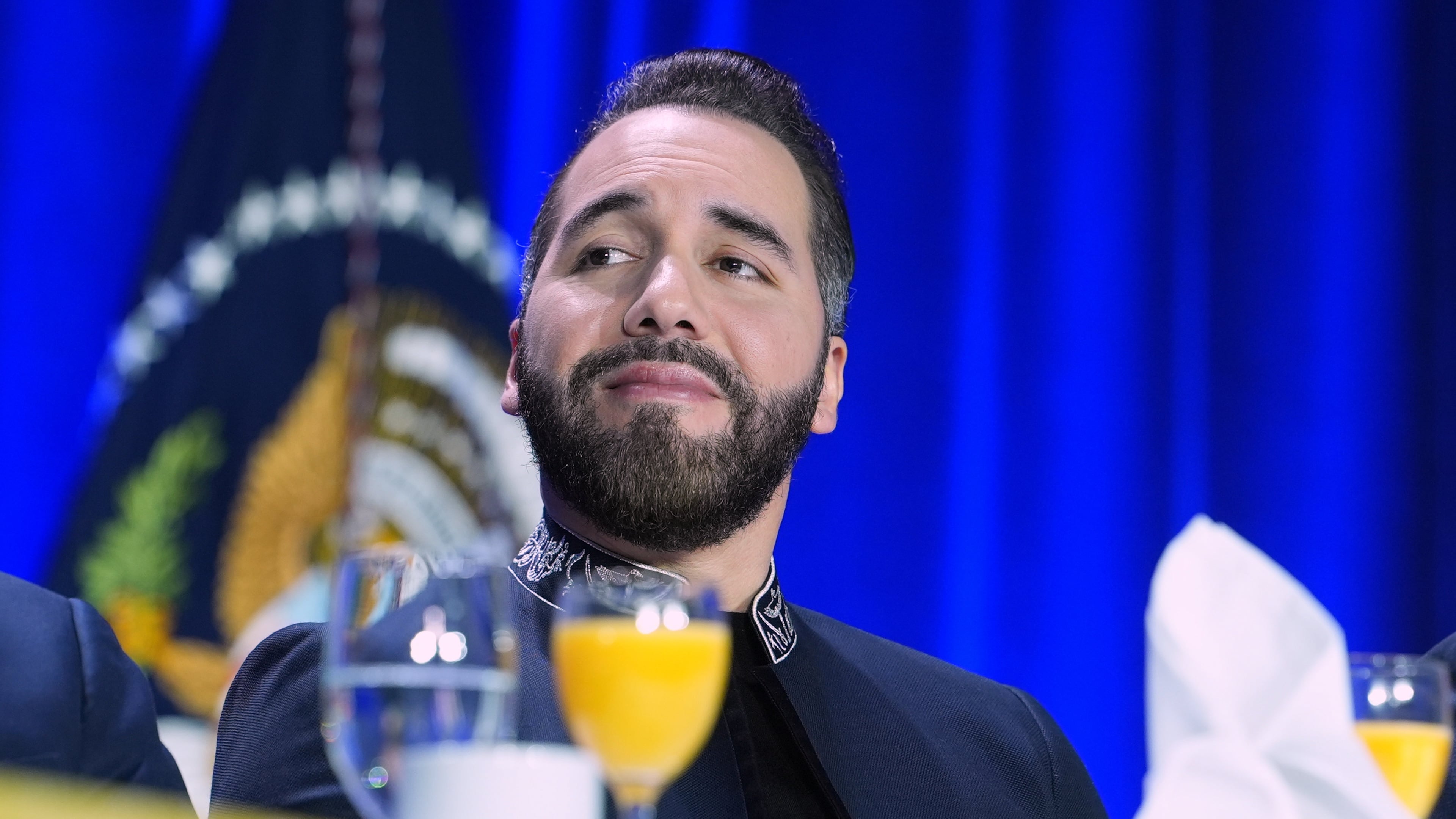 FILE - President of El Salvador, Nayib Armando Bukele Ortez, listens as President Donald Trump speaks during the National Prayer Breakfast, Feb. 5, 2026, in Washington. (AP Photo/Evan Vucci, File)
