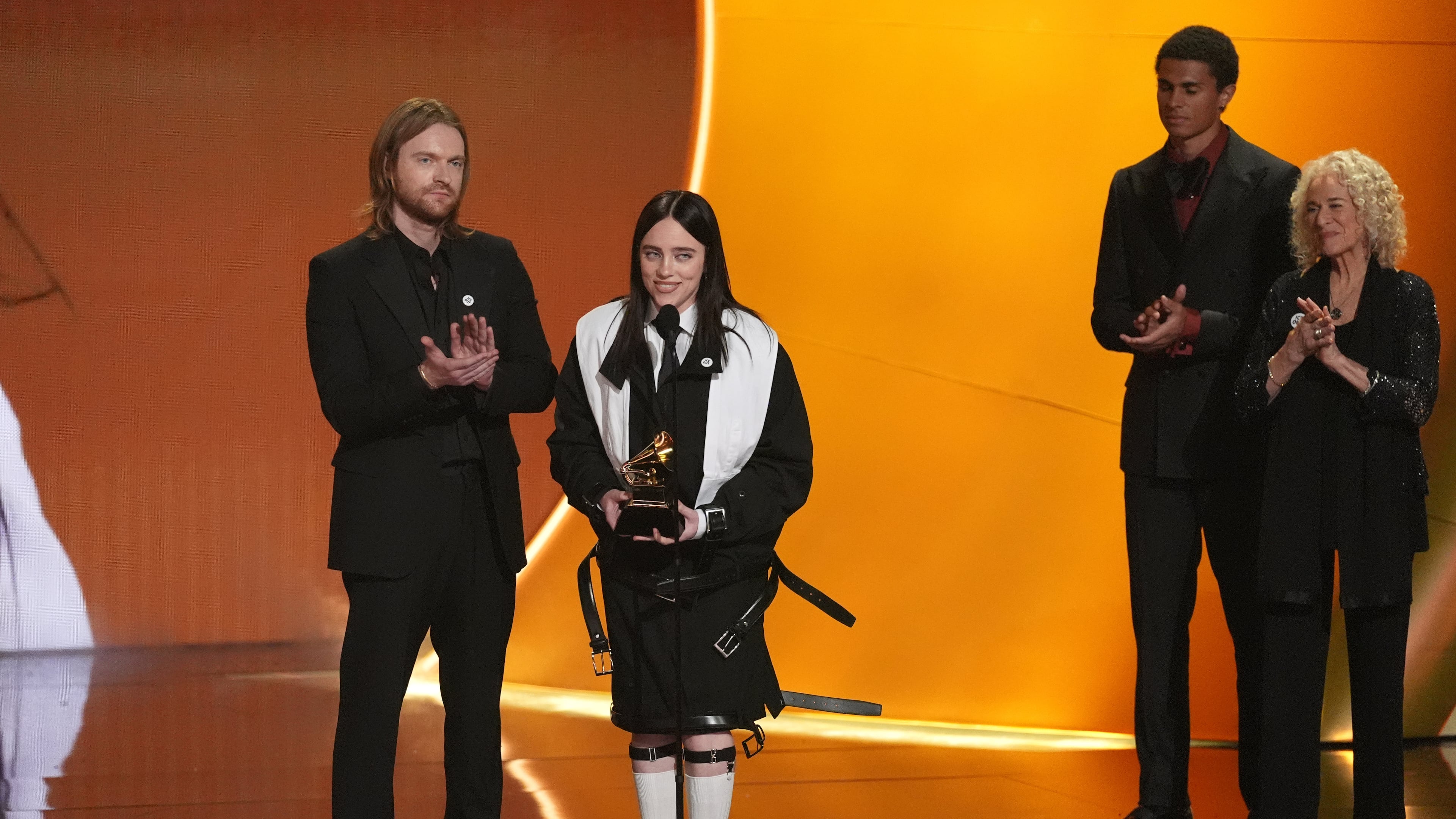 Finneas, left, and Billie Eilish accept the award for song of the year for "Wildflower" during the 68th annual Grammy Awards on Sunday, Feb. 1, 2026, in Los Angeles. Carole King looks on from right. (AP Photo/Chris Pizzello)