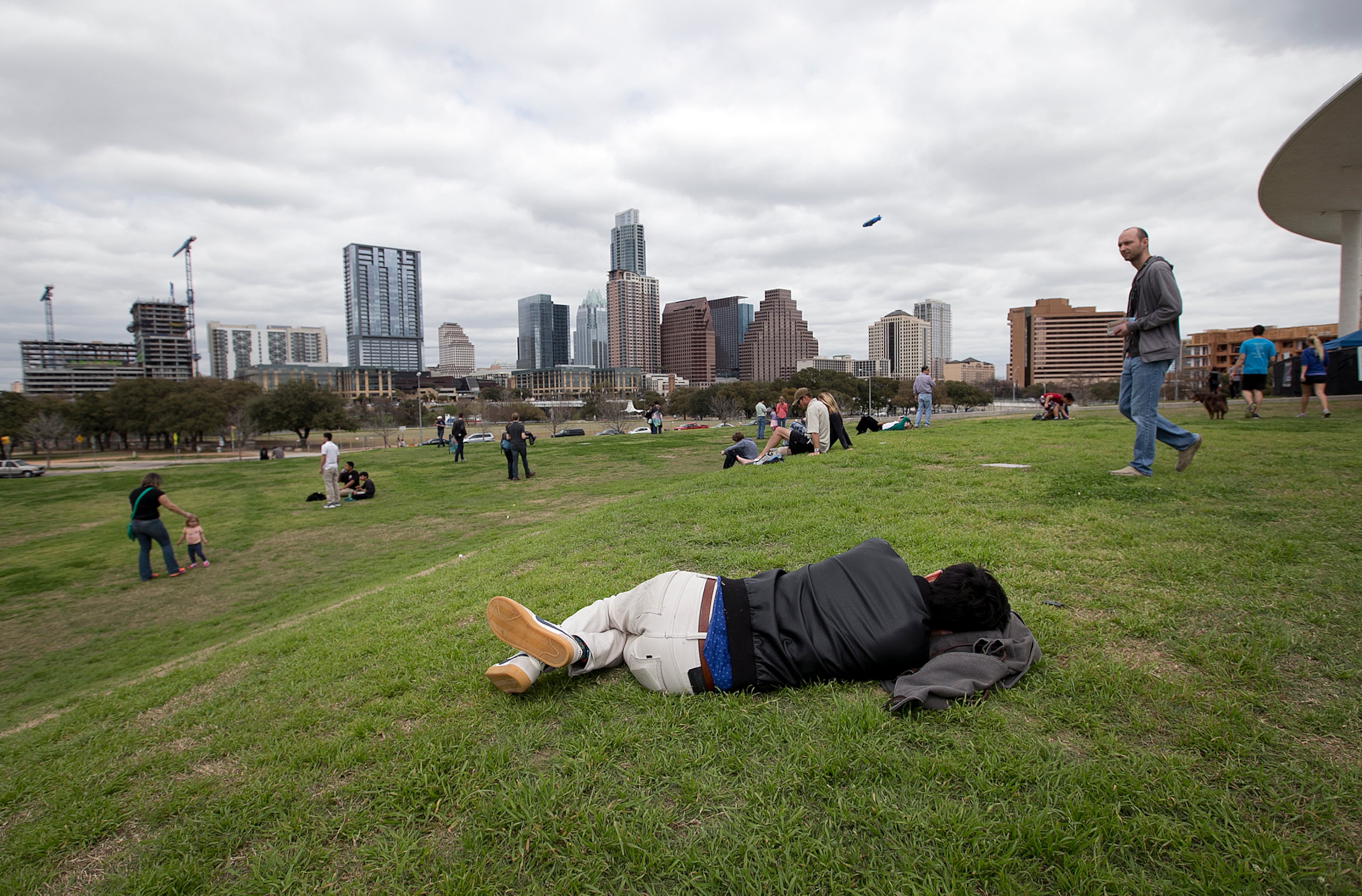 Anywhere you can find a clear spot is a good place to nap, such as this person relaxing outside the Long Center during SXSW at the Austin Convention Center on Sunday, March 15, 2015. DEBORAH CANNON / AMERICAN-STATESMAN