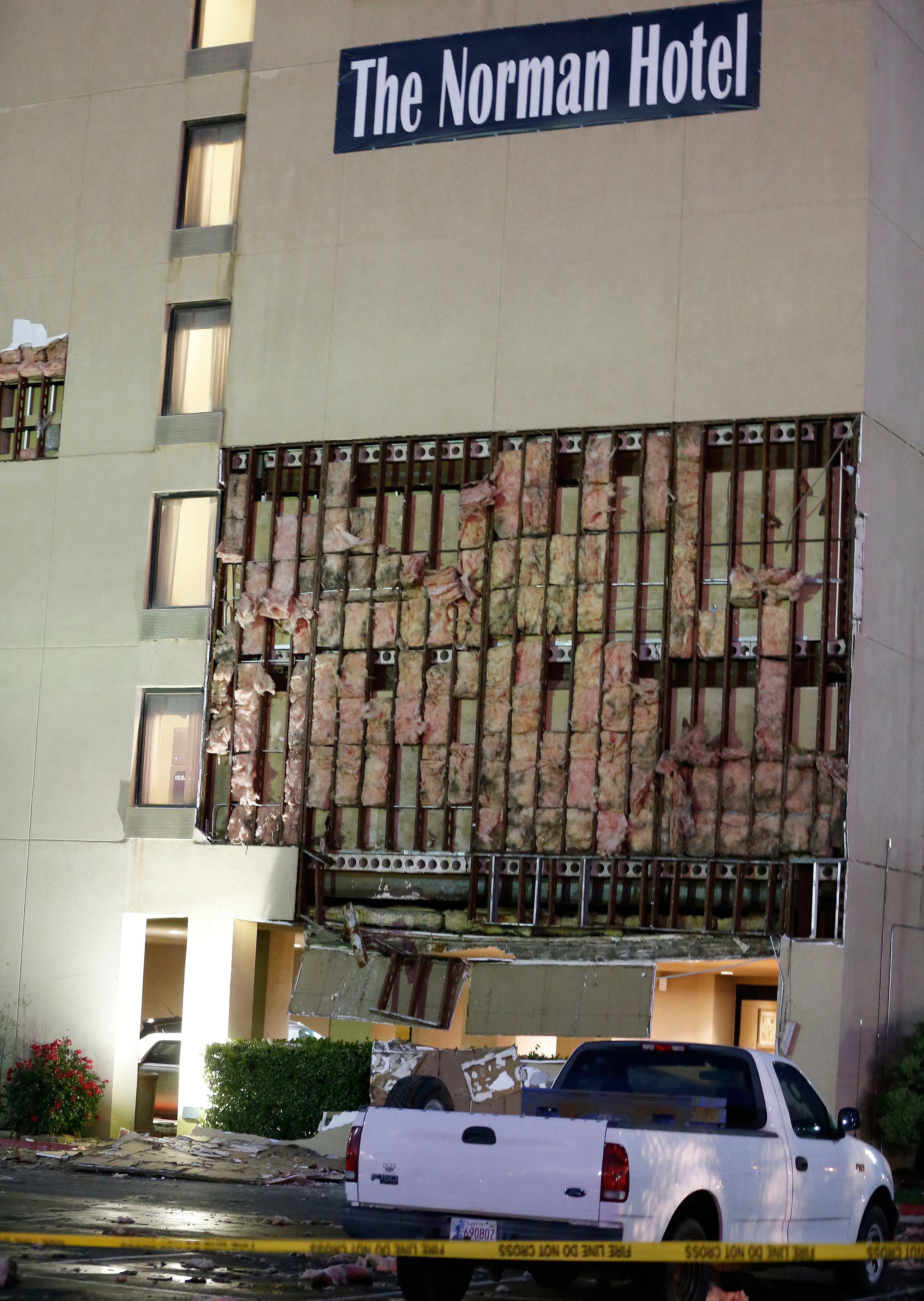 Debris scatters the parking lot of The Norman Hotel in Norman, Okla., on May 6, 2015. A tornado grazed Oklahoma City and its suburbs Wednesday, threatening rush hour drivers and prompting schools to hold children in safe rooms until the danger passed.
