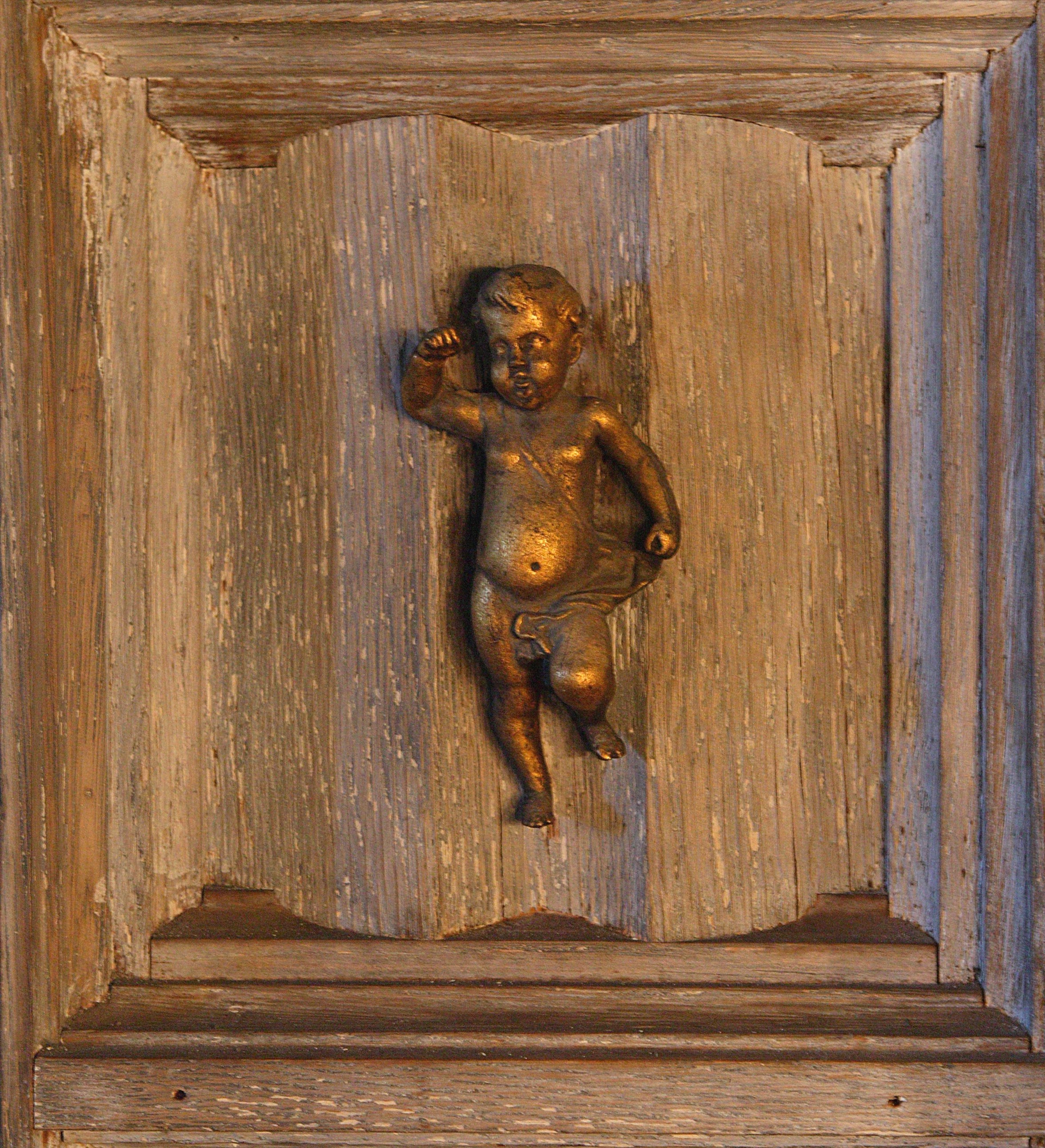 Cherub detail on doors in main living area leading to tea room (2005). Damon Higgins/Palm Beach Post