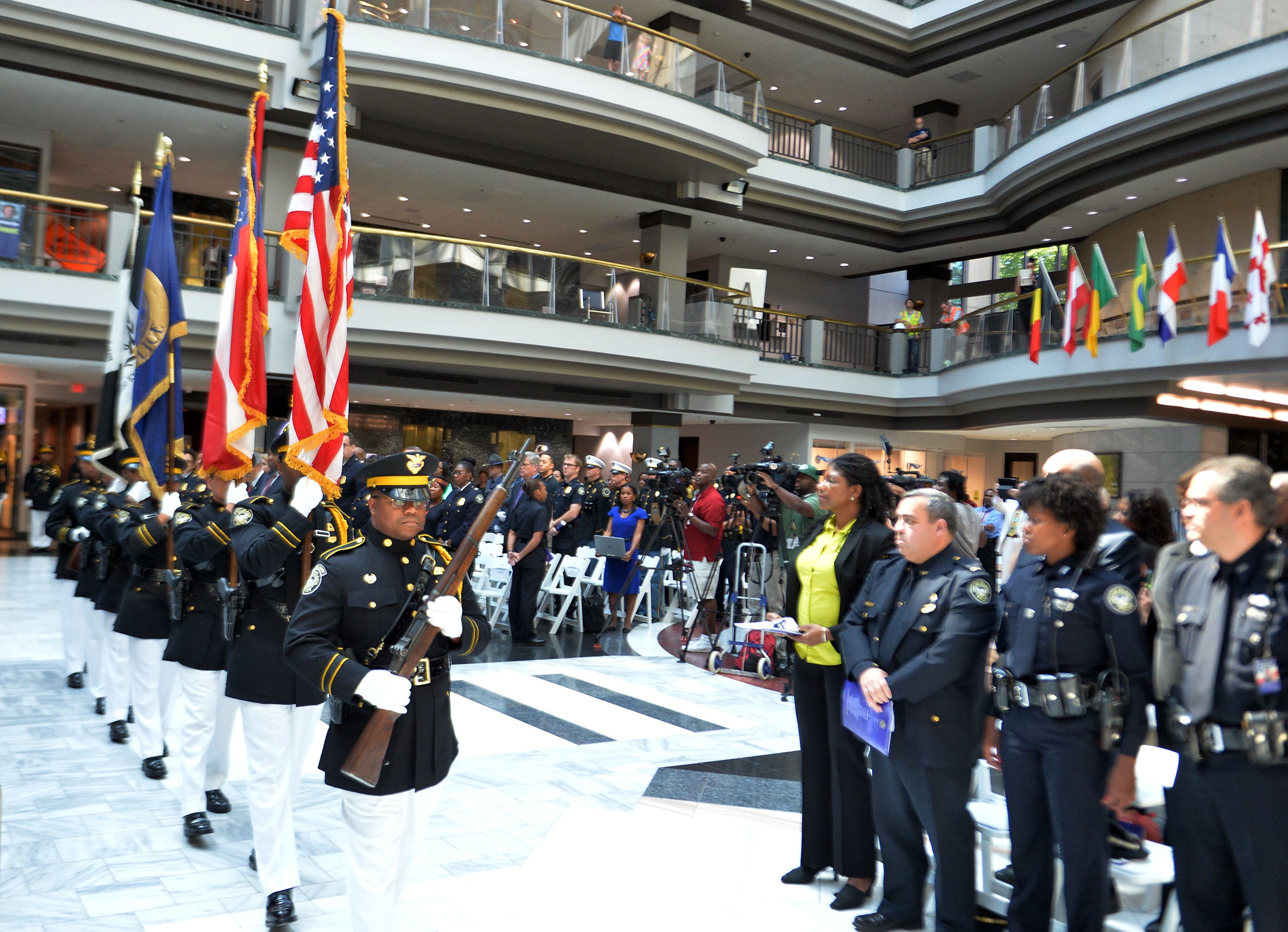 The APD Honor Guard posts the colors at the beginning of the service. The Atlanta Police Department recognized 82 fallen officers during the 24th Annual Police Memorial Service at the Atlanta City Hall atrium, Tuesday, May 5, 2015. The Right Rev. Robert C. Wright of the Episcopal Diocese of Atlanta was the keynote speaker. Additional speakers included Atlanta Police Chief George N. Turner, Michael Geisler, Chief Operating Officer, City Council President Ceasar C. Mitchell and Council member C.T. Martin, Public Safety Chair. KENT D. JOHNSON /KDJOHNSON@AJC.COM