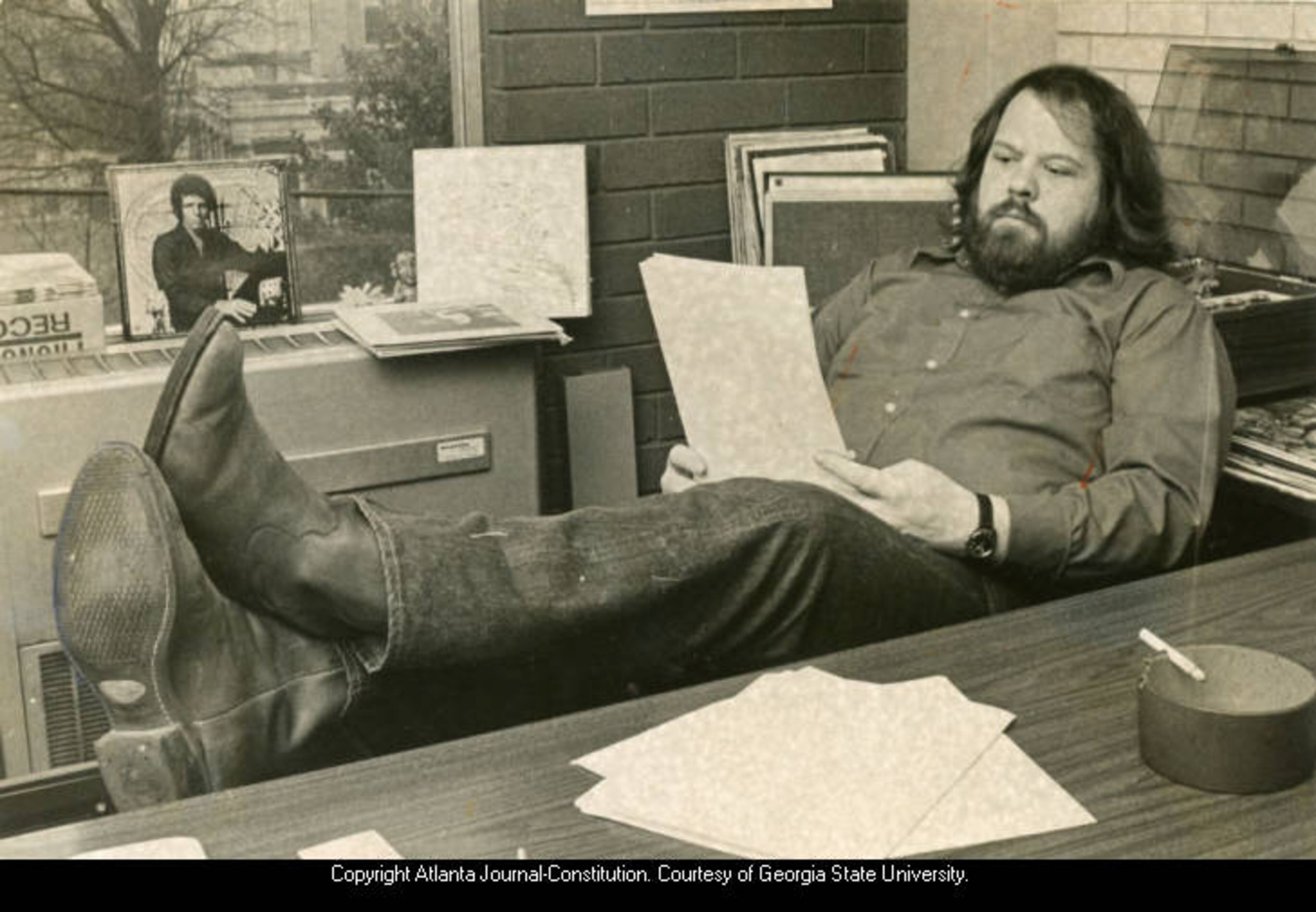 Feb. 2 1971 -- Music events promoter Alex Cooley, reading the anti-Pop Festival bill passed by the Georgia House of Representatives. CHARLES D. JACKSON / AJC PHOTO ARCHIVES