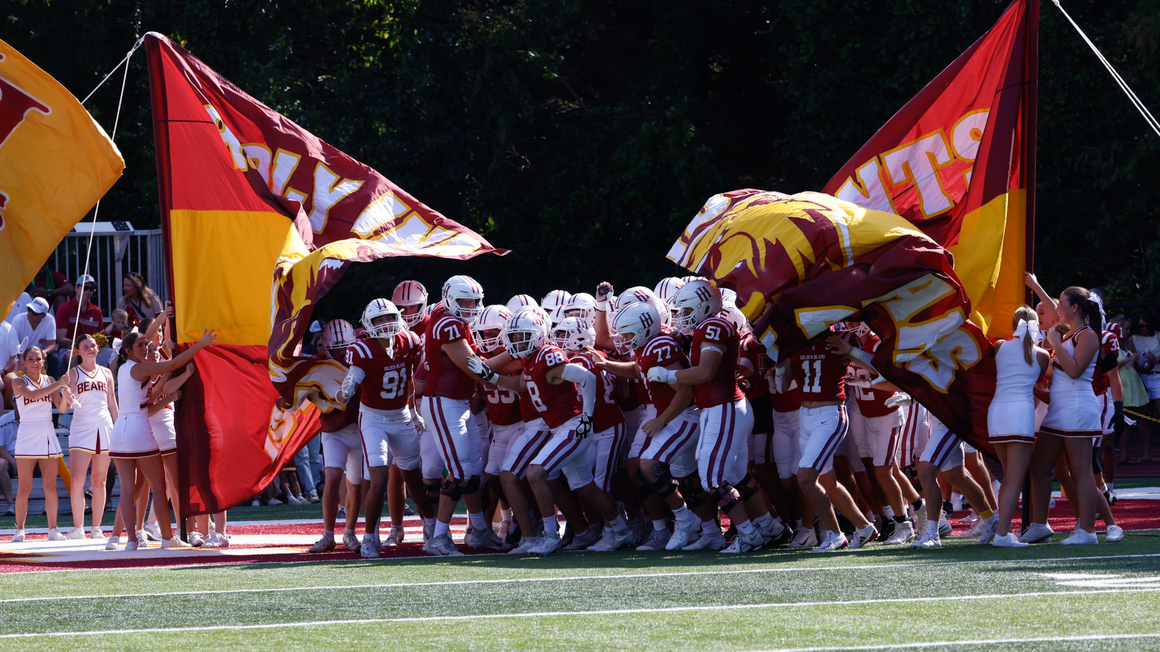 Holy Innocents' players break through the flag before the Mount Vernon vs. Holy Innocents' football game at Holy Innocents' Episcopal School in Atlanta on Sept. 4, 2026. (Arvin Temkar/AJC)