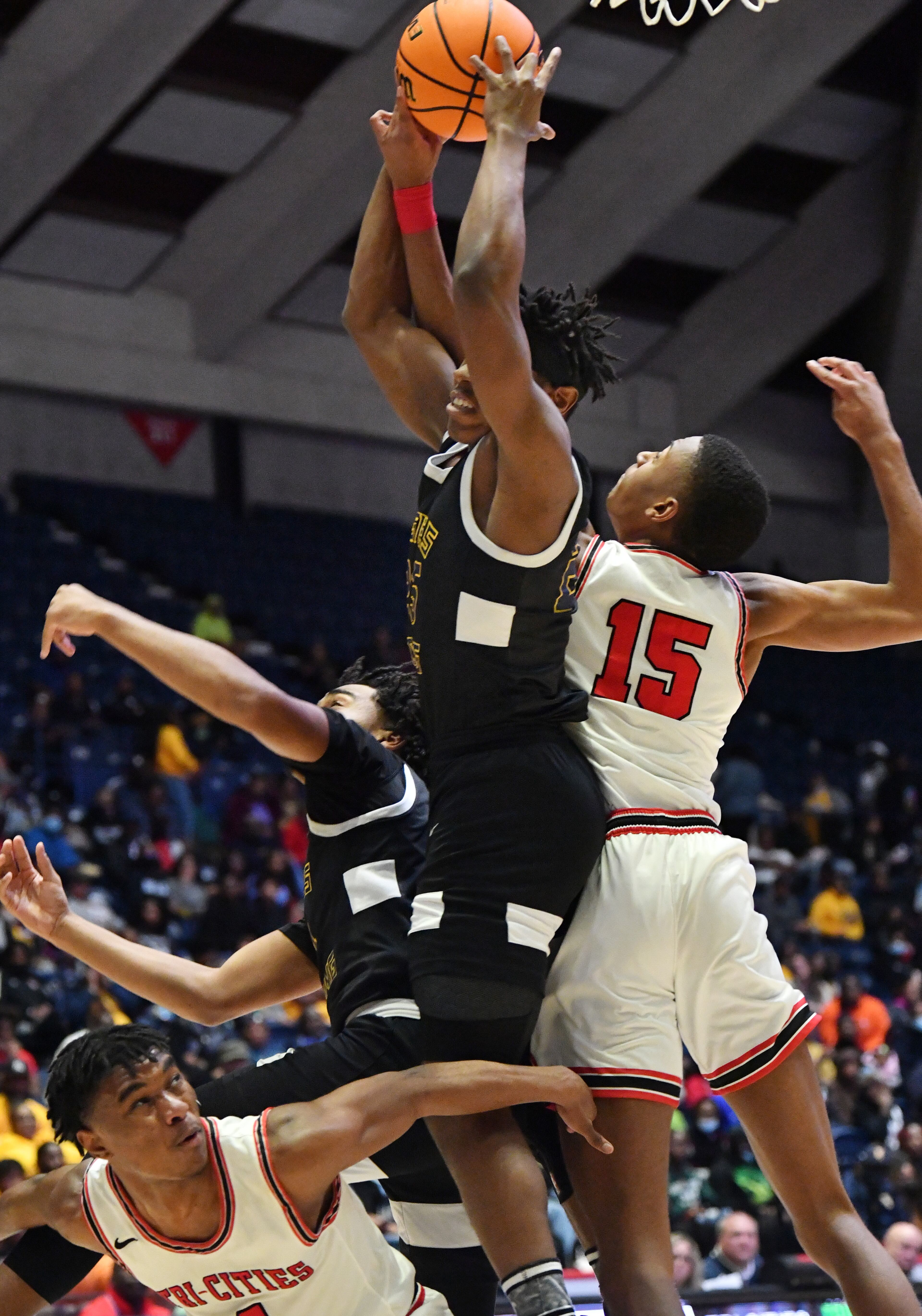 Eagle’s Landing's Jibrail Martin (middle) grabs a rebound over Tri-Cities players. (Hyosub Shin / Hyosub.Shin@ajc.com)