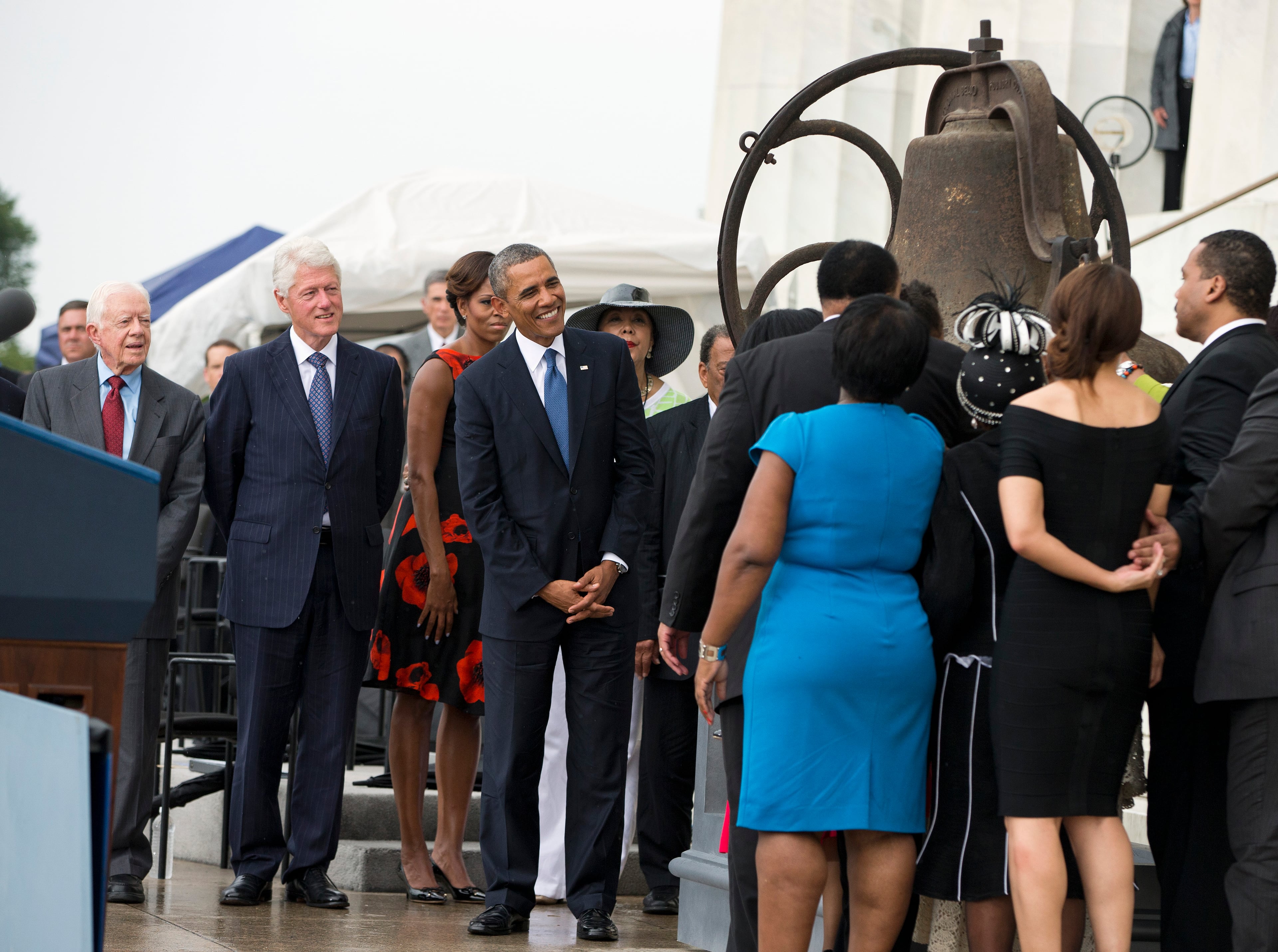 From left, former President Jimmy Carter, former President Bill Clinton, first lady Michelle Obama, and President Barack Obama look on as the family of Martin Luther King Jr. ring the bell from the 16th Street Baptist Church in Birmingham, Ala., that was destroyed in a bombing, during a ceremony commemorating the 50th anniversary of the March on Washington, Wednesday, Aug. 28, 2013, at the Lincoln Memorial in Washington. The president was set to lead civil rights pioneers Wednesday in a ceremony for the 50th anniversary of the March on Washington, where Dr. Martin Luther King's "I Have a Dream" speech roused the 250,000 people who rallied there decades ago for racial equality. (AP Photo/Evan Vucci)