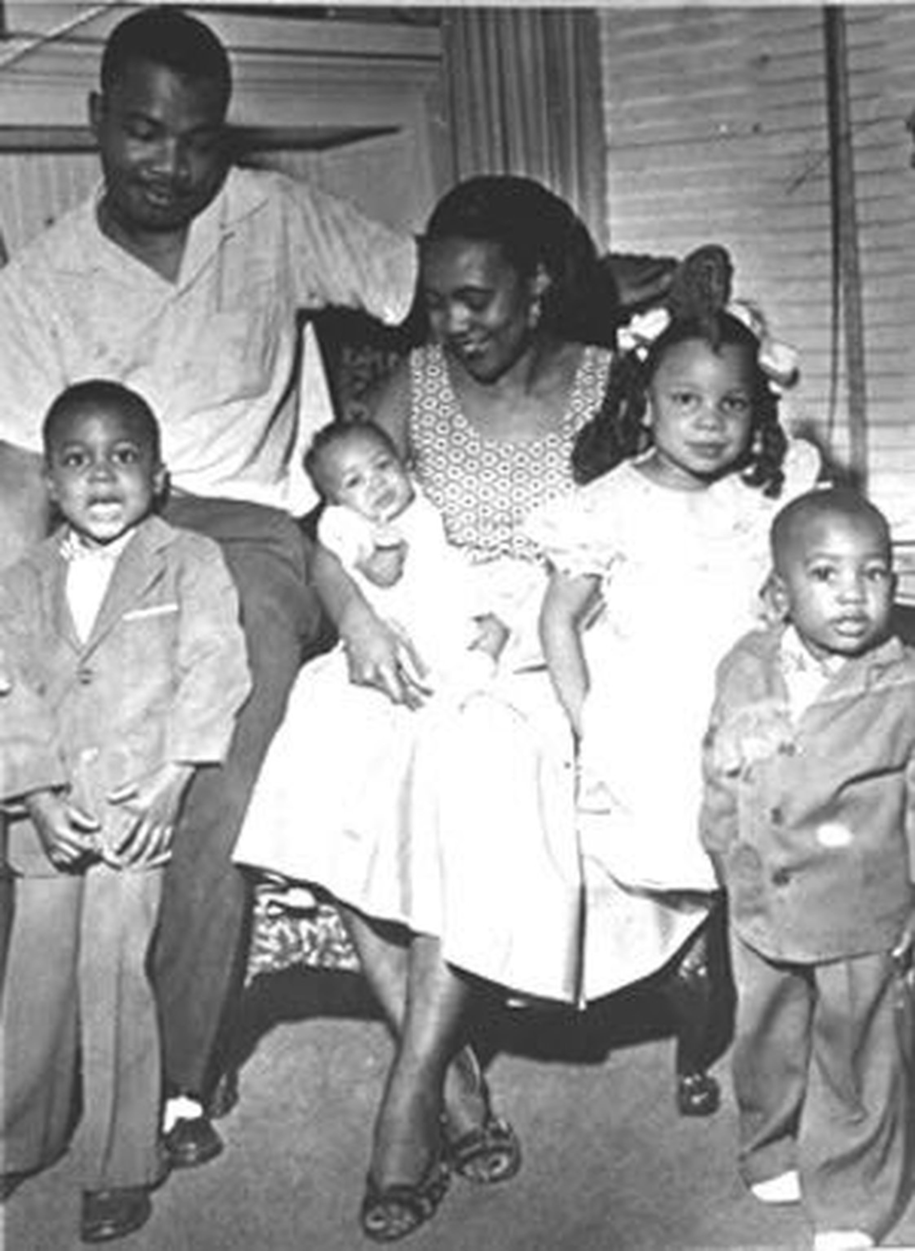 The (A.D.) King family. Gathered in the living room of their Auburn Avenue home in the early 1950s, Alveda King (girl in the white dress), leans on her mother, Naomi King. Her father, A.D. King, was the youngest brother of Martin Luther King Jr. He died in 1968. Her baby sister Darlene is in her mother’s lap, flanked her brothers Alfred II and Derek.