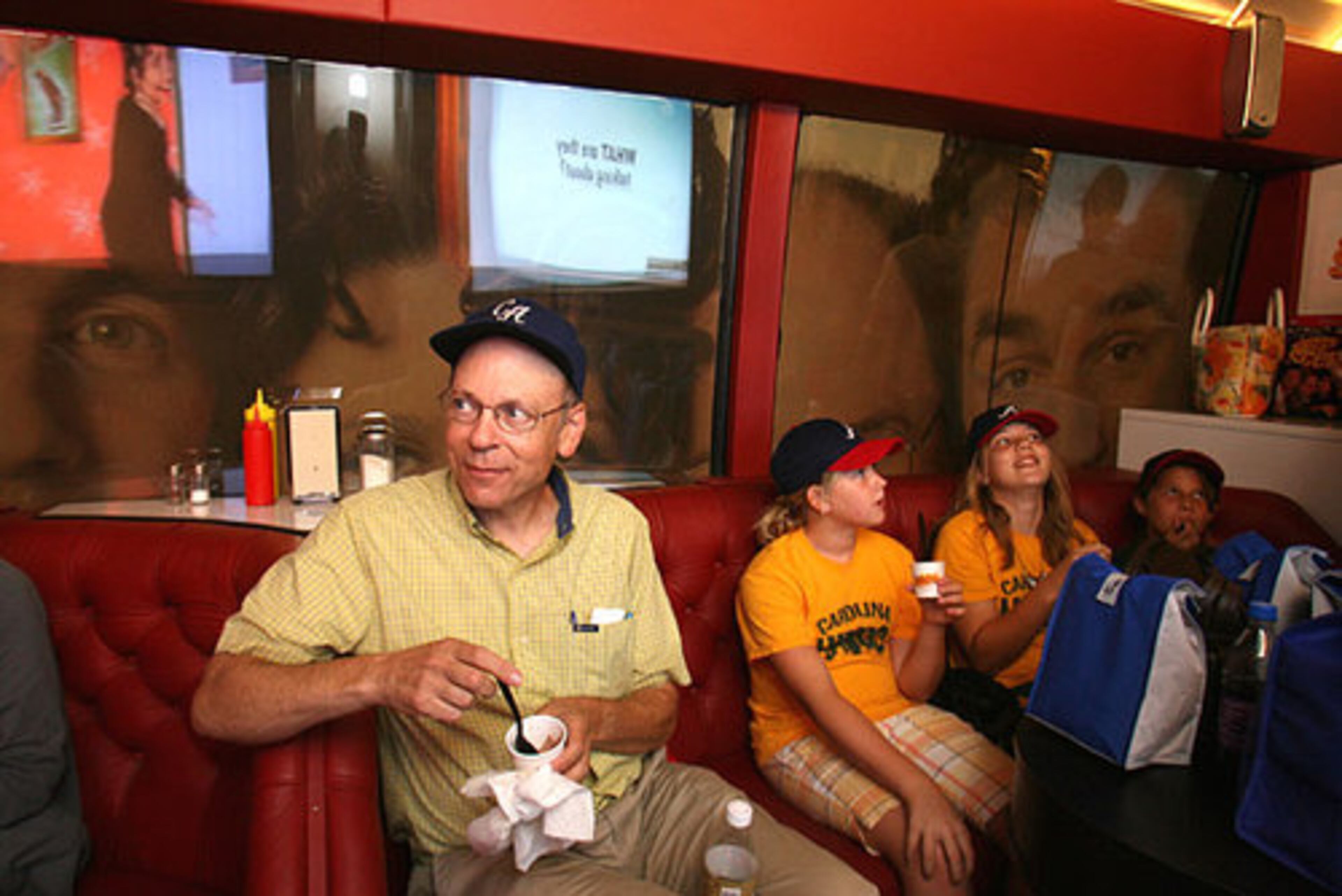 Longtime Seinfeld fan Leigh Rogoff (far left) of Atlanta enjoys a cup of frozen yogurt, as he sits alongside (left to right) Parker Williams, 11, Sydney Cole, 12, and Kayla Sigmon, 10, of Faith, N.C. Rogoff said he found the bus a treat since he thought the Seinfeld cast was "a superb comedy ensemble."