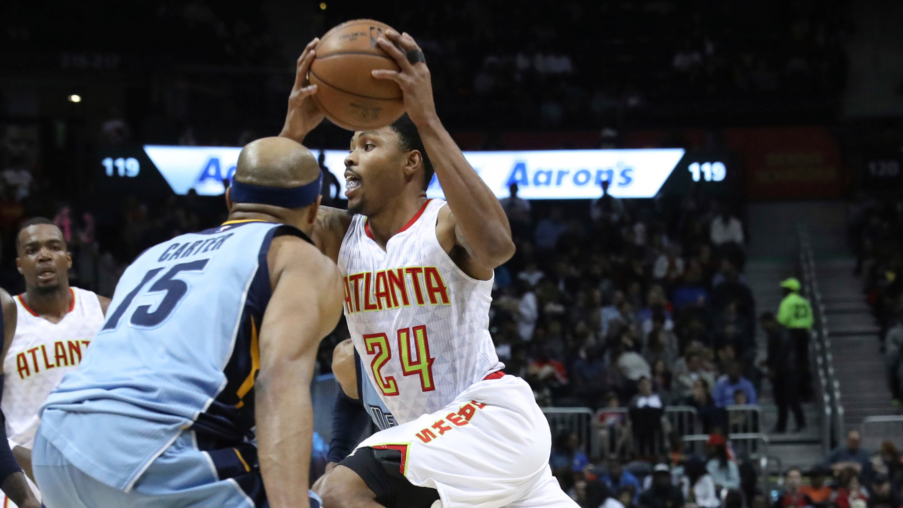 Atlanta Hawks forward Kent Bazemore (24) drives the ball past Memphis Grizzlies guard Vince Carter (15) during the second half of an NBA basketball game, Thursday, March 16, 2017, in Atlanta. The Grizzlies defeated the Hawks 103-91. (AP Photo/Branden Camp)