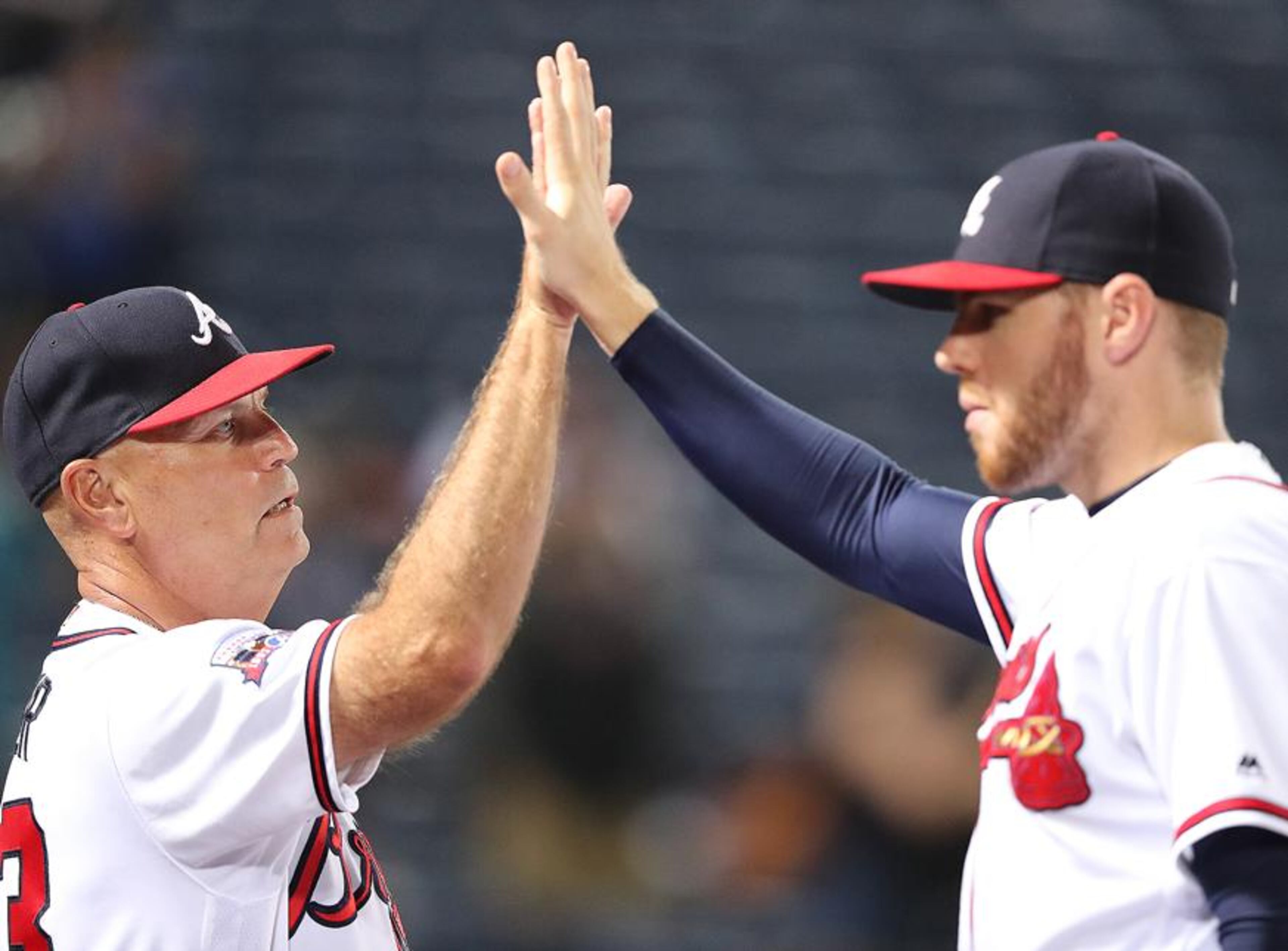 Brian Snitker (left) was named to replace fired Braves manager Fredi Gonzalez in May, and the strong performance of Freddie Freeman (right) helped assure Snitker would shed the interim label after the season ended. (Curtis Compton/AJC photo)