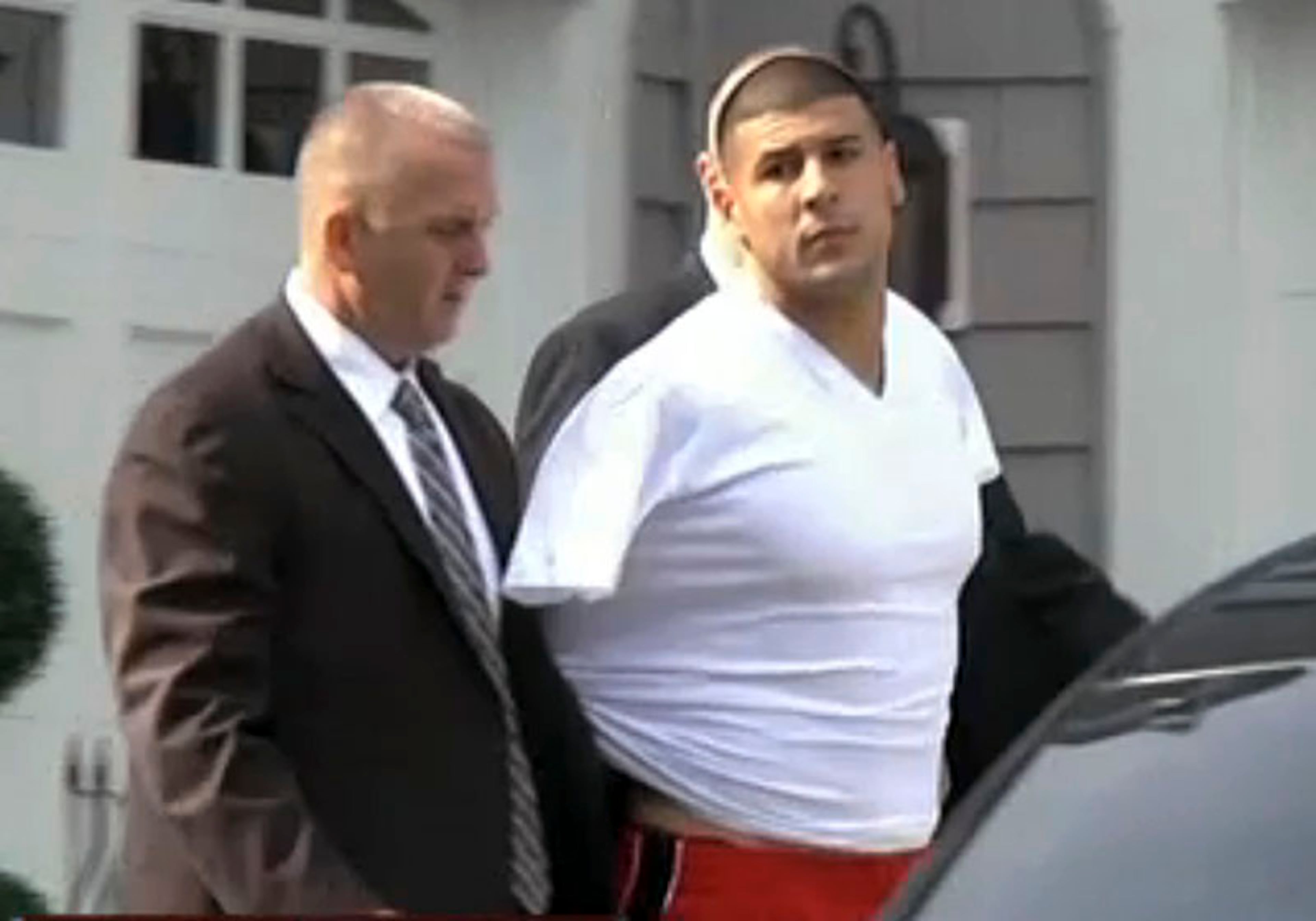 New England Patriots tight end Aaron Hernandez was taken into custody June 26 in connection with the homicide of a man near his home in North Attleboro, Mass. Two hours later, the Patriots released Hernandez.