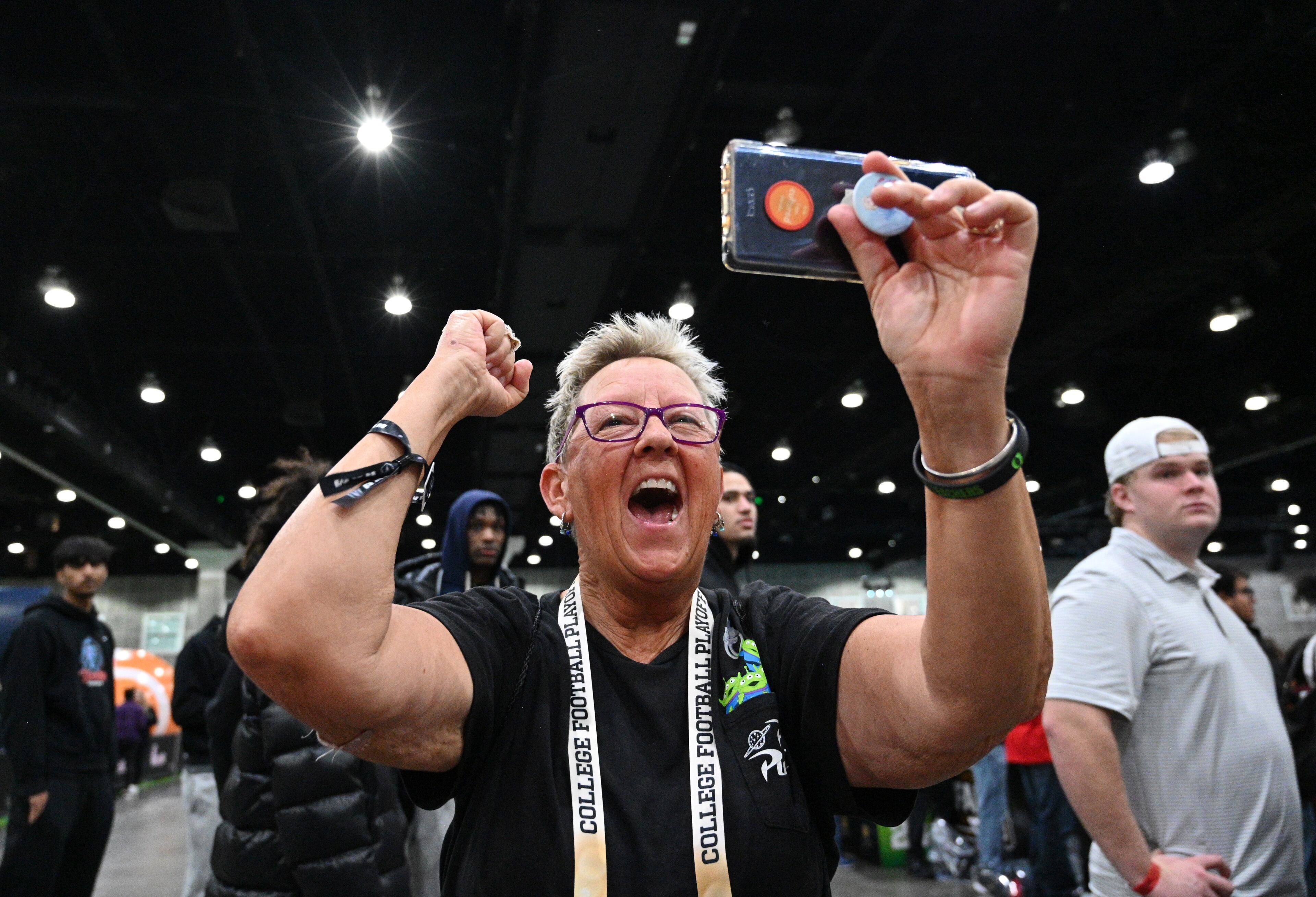 Georgia fans cheer as Georgia Redcoat Marching Band, cheerleaders, baton twirlers and Hairy Dog perform during a pep rally at the Playoff Fan Central at the LA Convention Center, Sunday., Jan. 8, 2023, in Los Angeles. (Hyosub Shin / Hyosub.Shin@ajc.com)