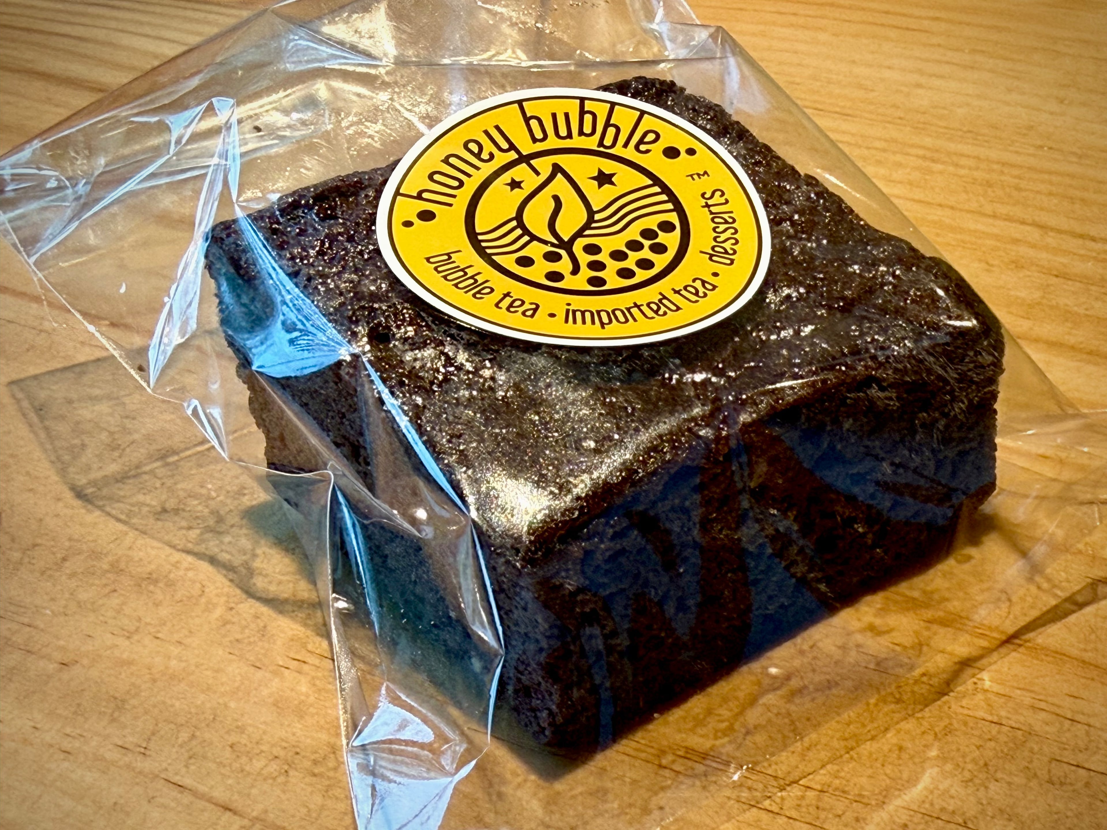 Honey Bubble’s “famous” brownie gains depth from the inclusion of taro, even if the texture is more like cake. (Henri Hollis/AJC)