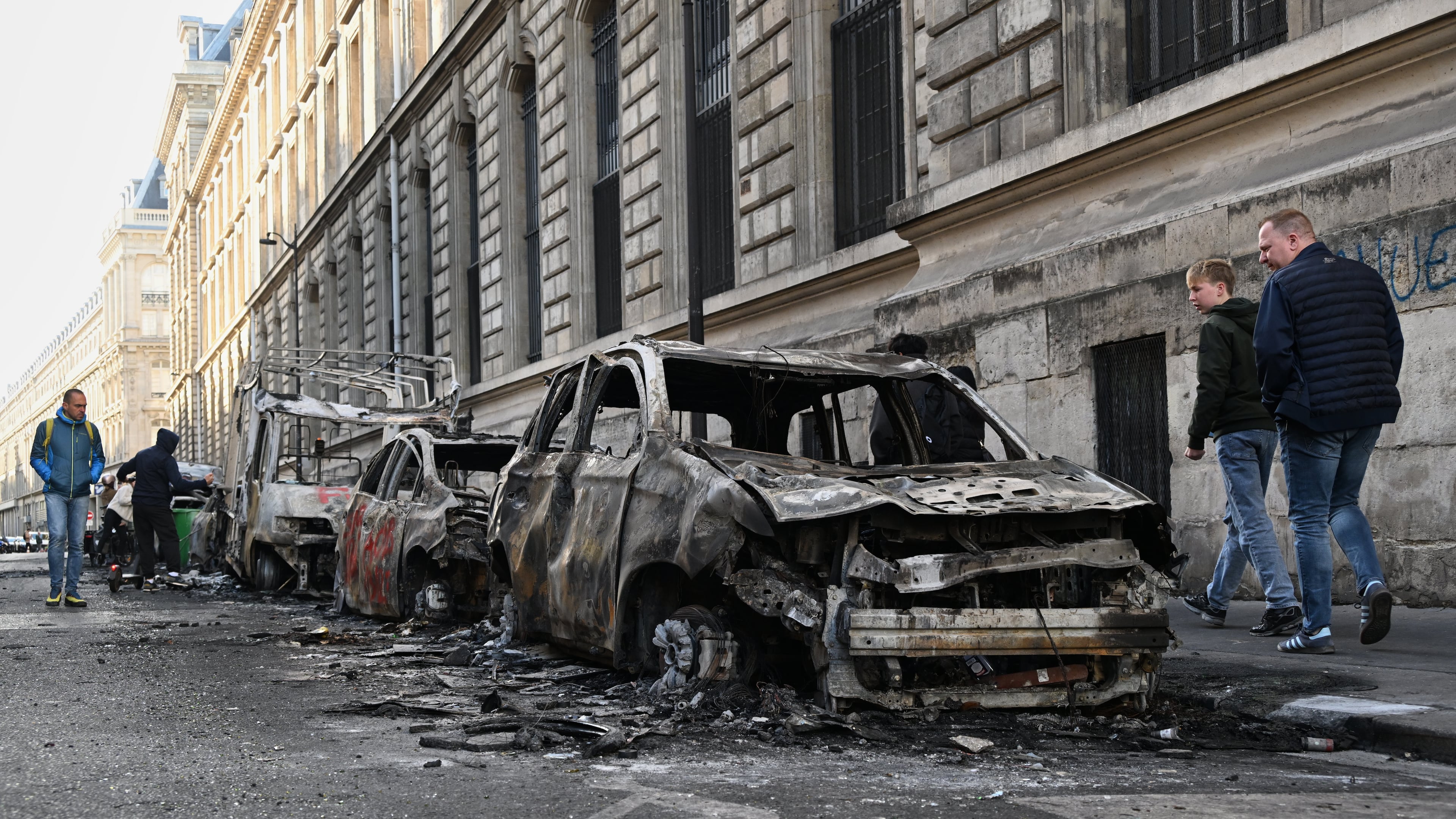 People look at charred cars the day after a demonstration against rising living costs, joining students' grievances, in Paris, Sunday, Oct. 18, 2026. (AP Photo/Emma Da Silva)