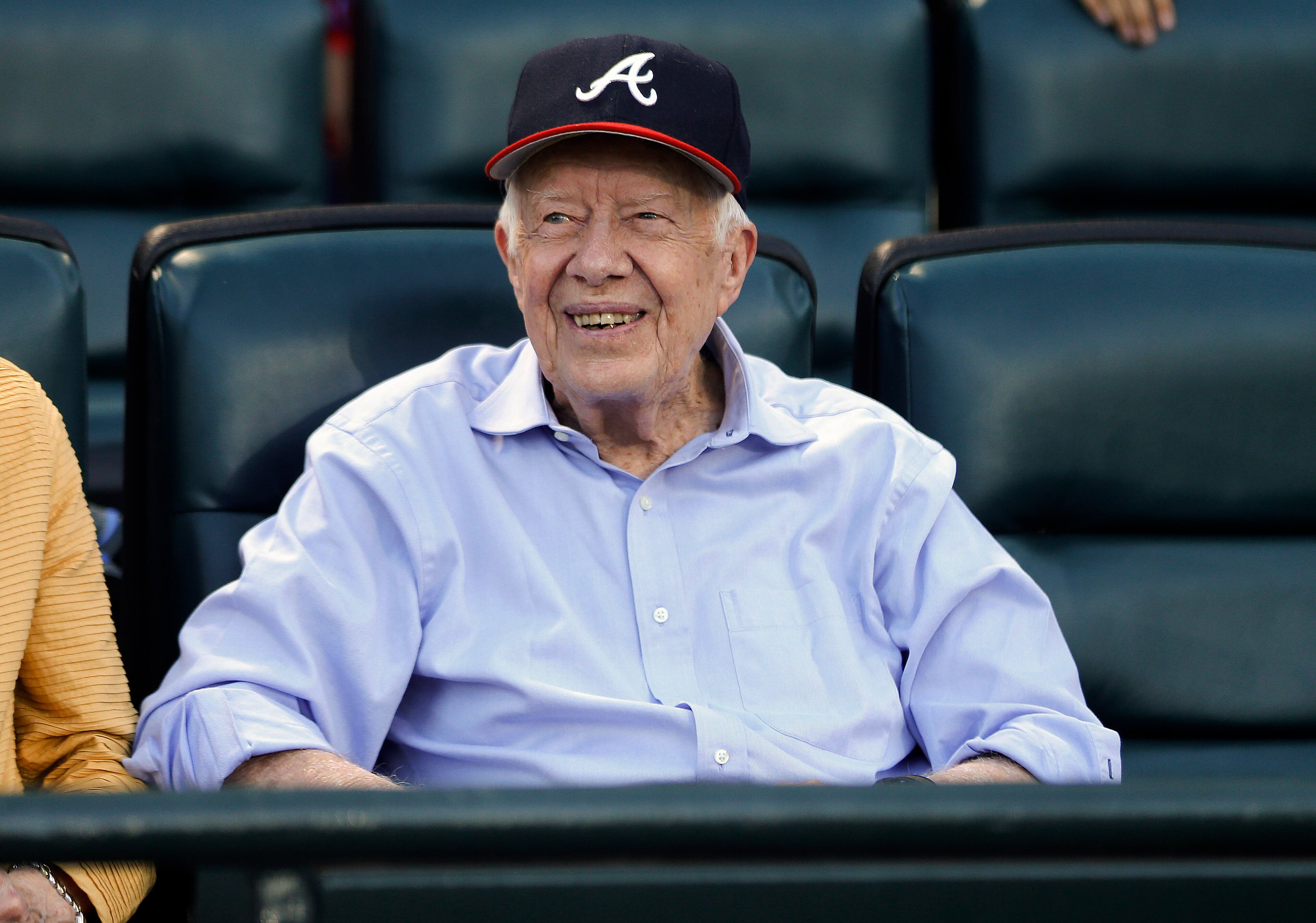 Former President Jimmy Carter watches a baseball game between the Atlanta Braves and the Toronto Blue Jays on Thursday, Sept. 17, 2015, in Atlanta. Carter recently announced he has cancer. (AP Photo/John Bazemore)