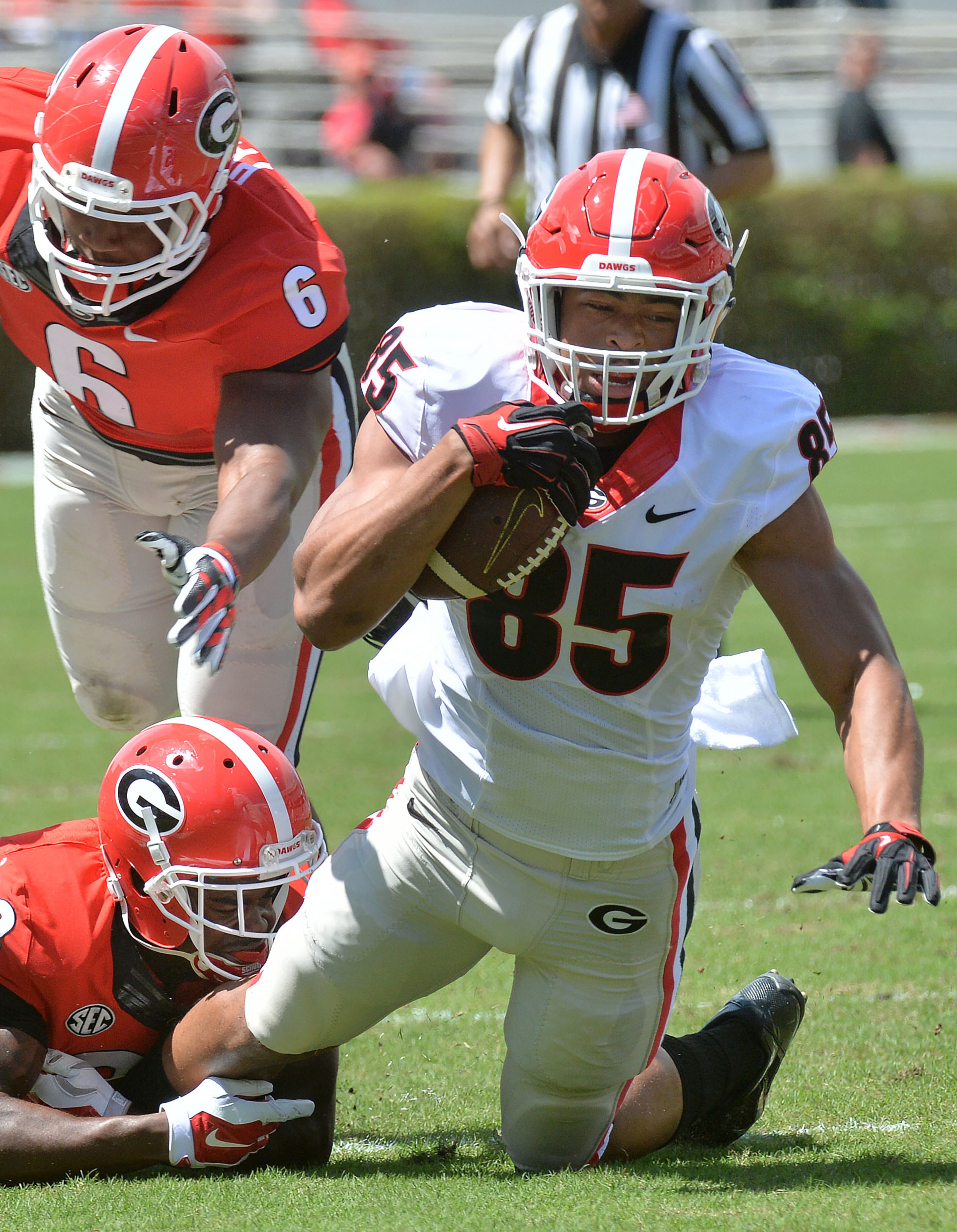 Georgia Bulldogs tight end Jordan Davis (85) gets tackled from behind by Georgia Bulldogs running back Kyle Vagher (28) during the 2015 Georgia Bulldogs G-Day game at Sanford Stadium in Athens on Saturday, April 11, 2015. HYOSUB SHIN / HSHIN@AJC.COM