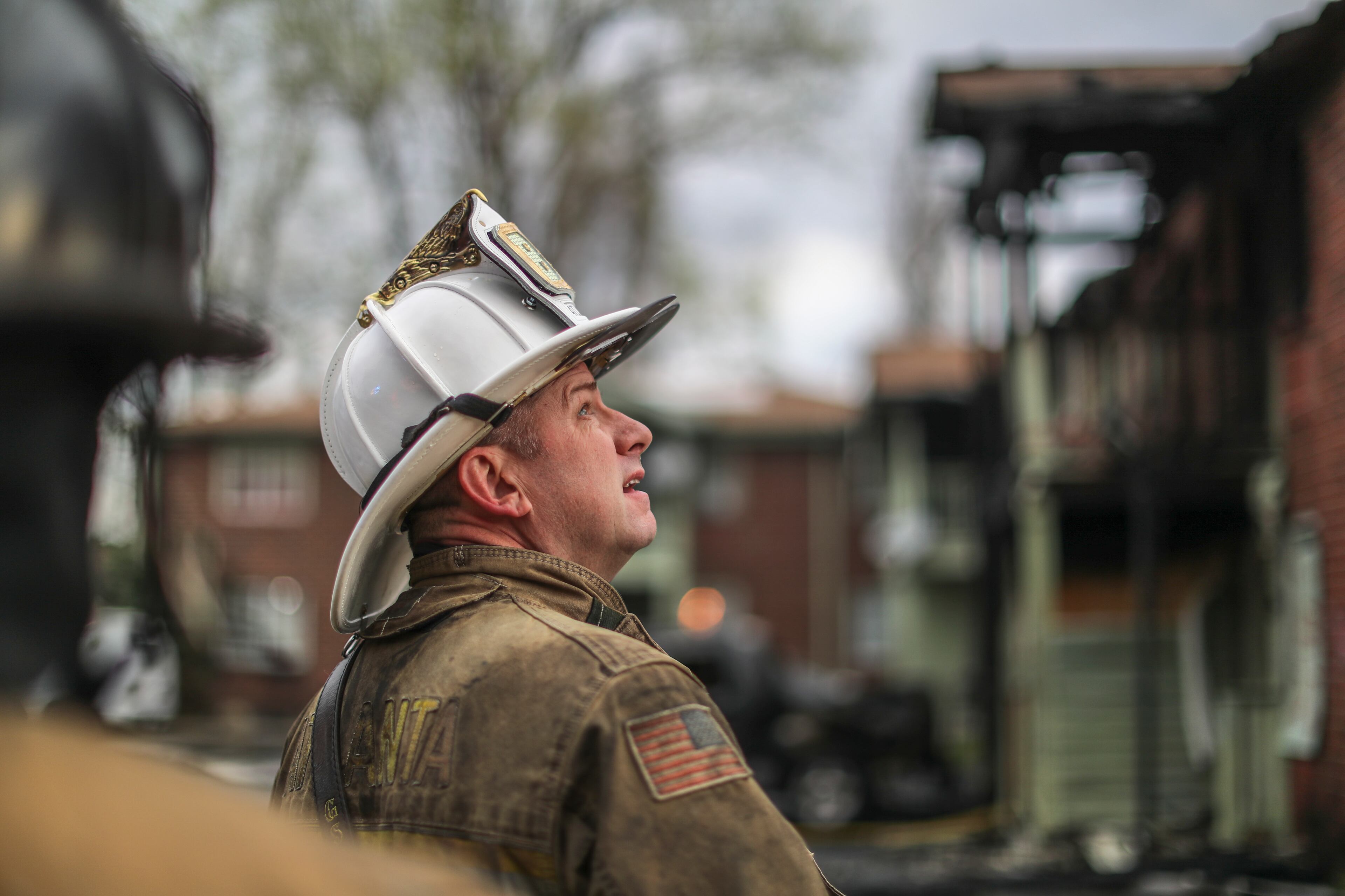Battalion Chief Derek Hullander looks over the structure where a fire at an apartment building on Joseph E. Boone Boulevard left one person dead Tuesday morning, March 29, 2022. Another person required treatment for smoke inhalation. When firefighters arrived, there was heavy fire in the first- and second-floor units of the A building, Hullander said.” (John Spink / John.Spink@ajc.com)