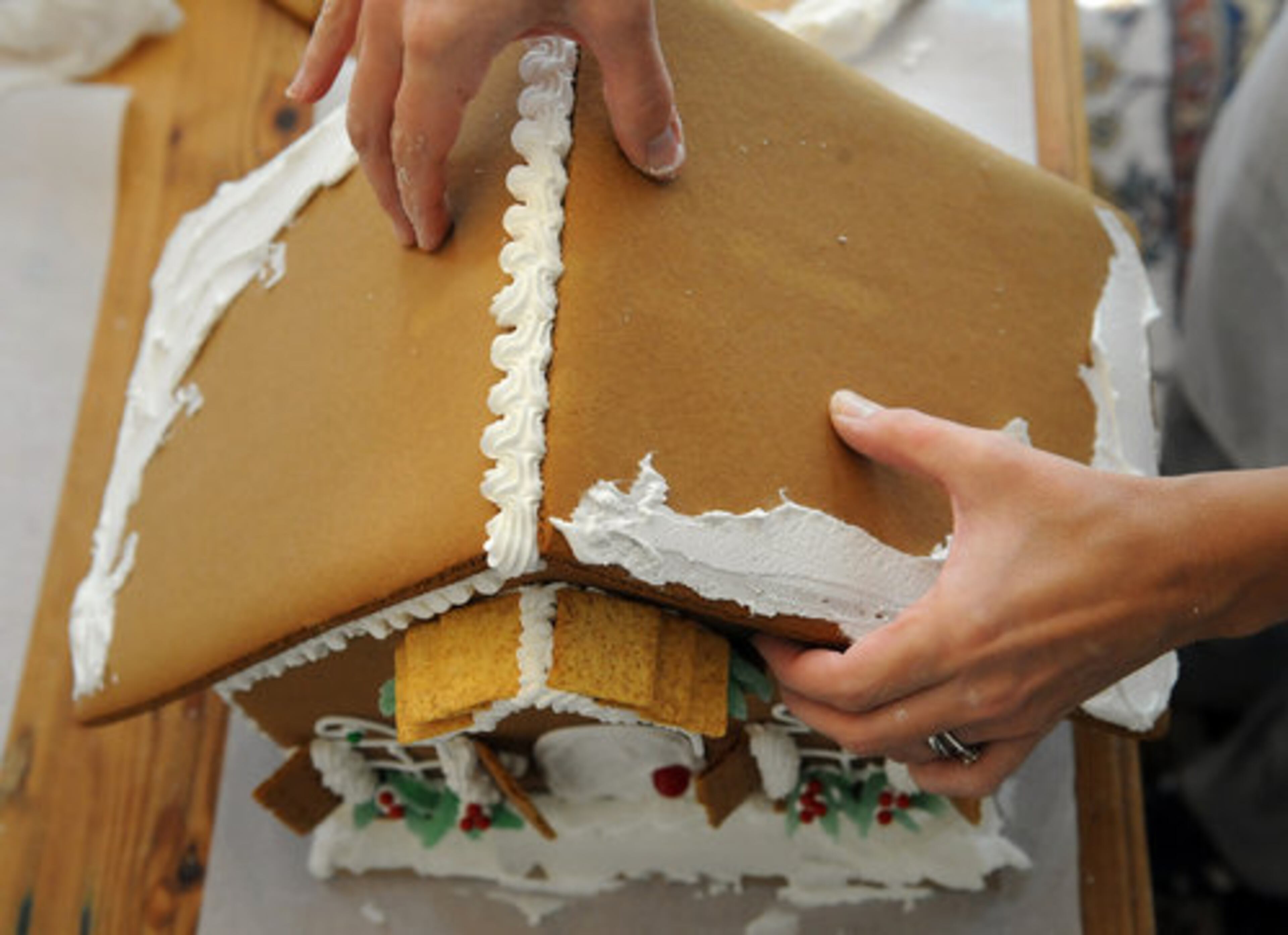 Place the second side of the roof on using the same technique, then repeat a thick border down the center of the roof to be sure it adheres. HYOSUB SHIN / HSHIN@AJC.COM