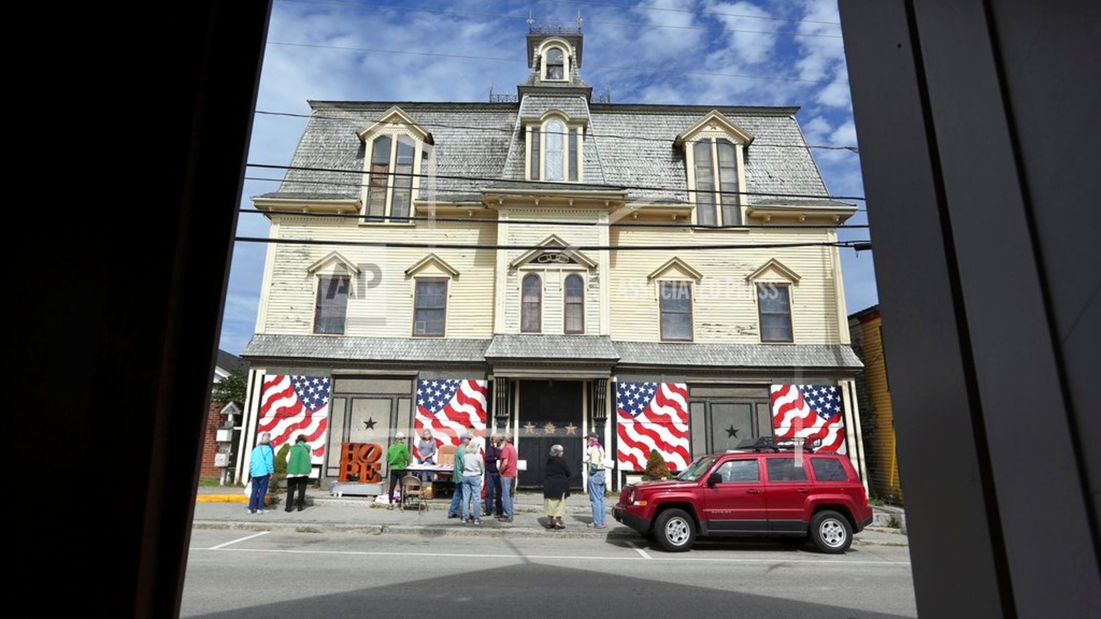 FILE - In this Sept. 13, 2014, file photo, fans gather outside "Star of Hope" the residence of artist Robert Indiana on Vinalhaven Island, Maine. Indiana died on May 19, 2018. His will calls for his home and studio to be transformed into a museum and for his collection to be preserved and open to the public. (AP Photo/Robert F. Bukaty, File)