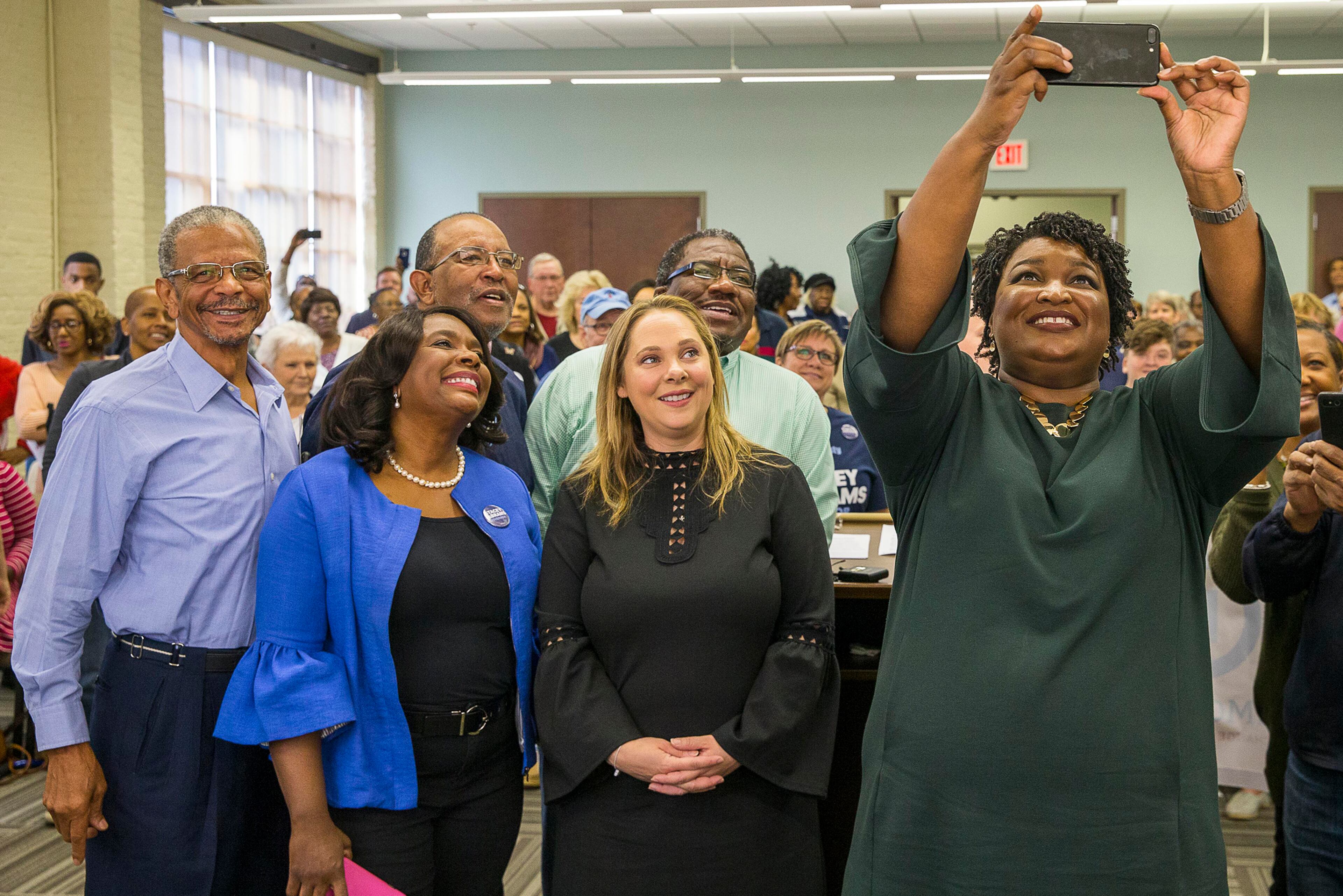 10/29/2018 -- Madison, Georgia -- Gubernatorial candidate Stacey Abrams takes a selfie with Democratic candidate for Lieutenant Governor Sarah Riggs Amico (center), Alabama 7th Congressional District Congresswoman Terri A. Sewell (second from left) and her supporters during an early voters rally in Madison, Monday, October 29, 2018. Stacey Abrams was joined by Georgia Democratic candidate for Lieutenant Governor Sarah Riggs Amico and Democratic Attorney General candidate Charlie Bailey at the Madison stop of the "We Are Georgia - Our Voices. Our Votes. Our Time" Bus Tour. (ALYSSA POINTER/ALYSSA.POINTER@AJC.COM)