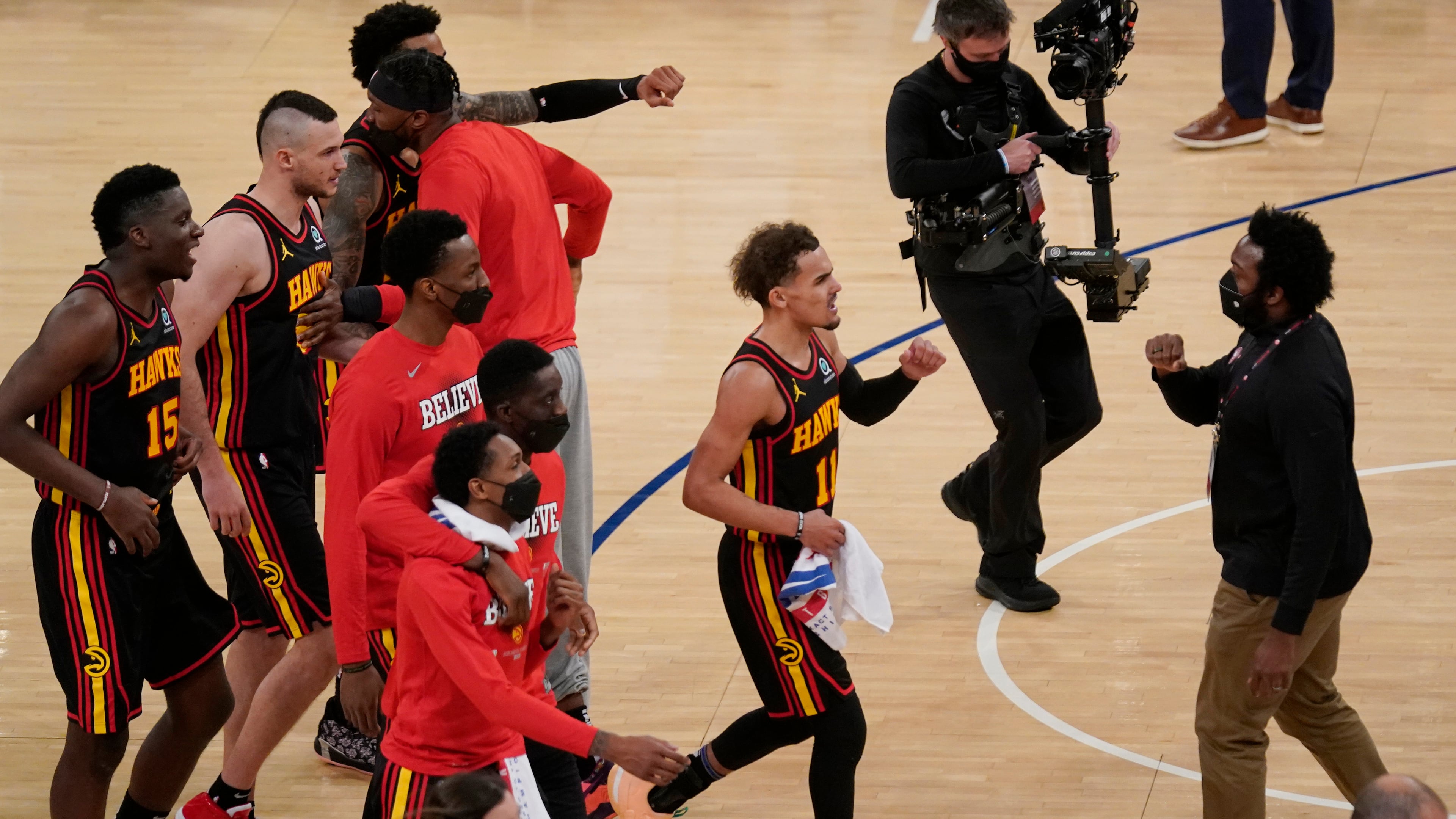 Atlanta Hawks' Trae Young (11) and the rest of team celebrate after Game 1 win in first-round playoff series against the New York Knicks, Sunday, May 23, 2021, in New York. The Hawks won 107-105. (Seth Wenig/AP)
