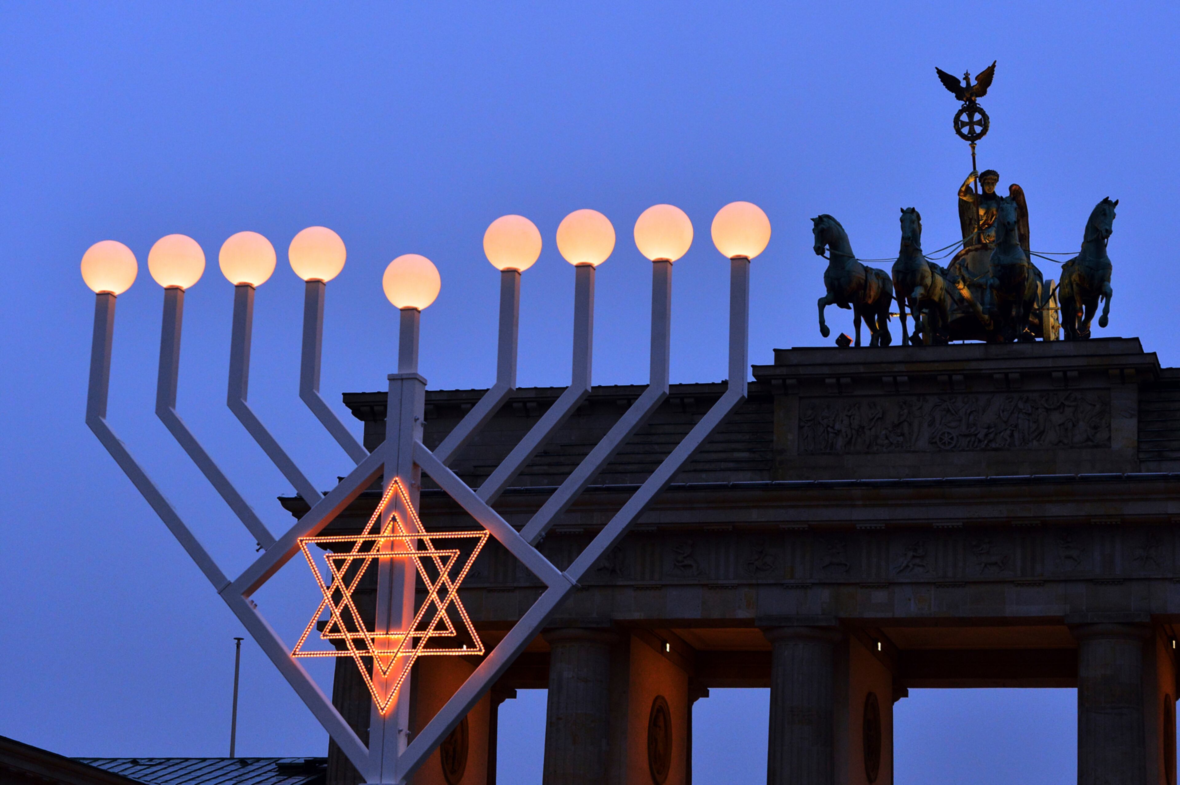 Europe's largest menorah is lit up at the Brandenburg Gate in Berlin,'Germany, Thursday, Dec. 22, 2016. This year's Hanukkah celebration is dedicated to the victims of the attack at the Christmas market on Breitscheidplatz. (Maurizio Gambarini/dpa via AP)