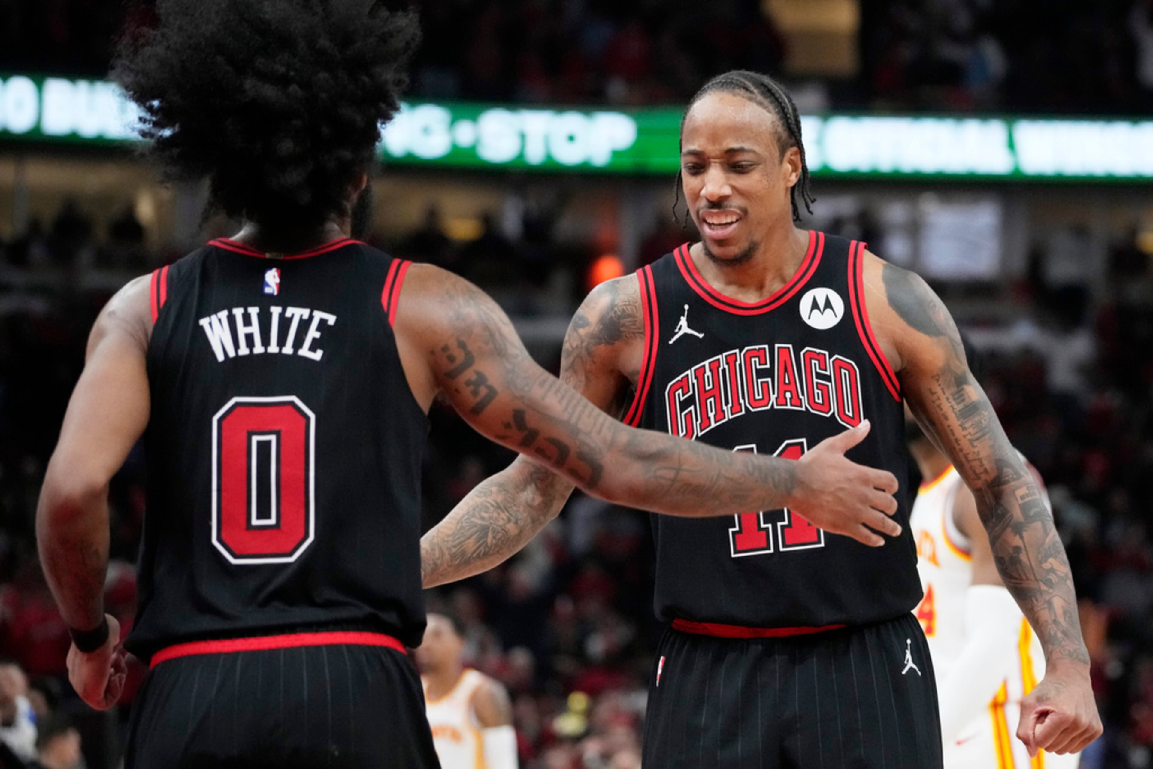 Chicago Bulls guard Coby White, left, celebrates with forward DeMar DeRozan after scoring against the Atlanta Hawks during the second half of an NBA basketball play-in tournament game in Chicago, Wednesday, April 17, 2024. The Bulls won 131-116. (AP Photo/Nam Y. Huh)
