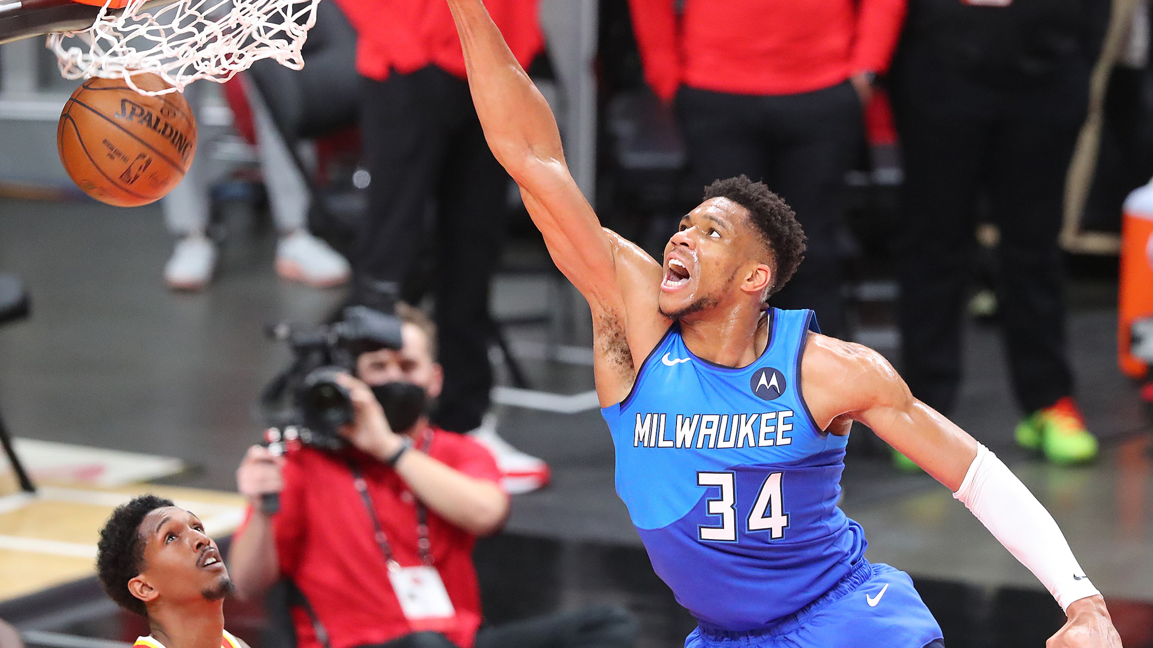 Milwaukee Bucks forward Giannis Antetokounmpo slams over Atlanta Hawks guard Lou Williams during the second quarter of Game 3 of the Eastern Conference finals Sunday, June 27, 2021, in Atlanta. (Curtis Compton / Curtis.Compton@ajc.com)