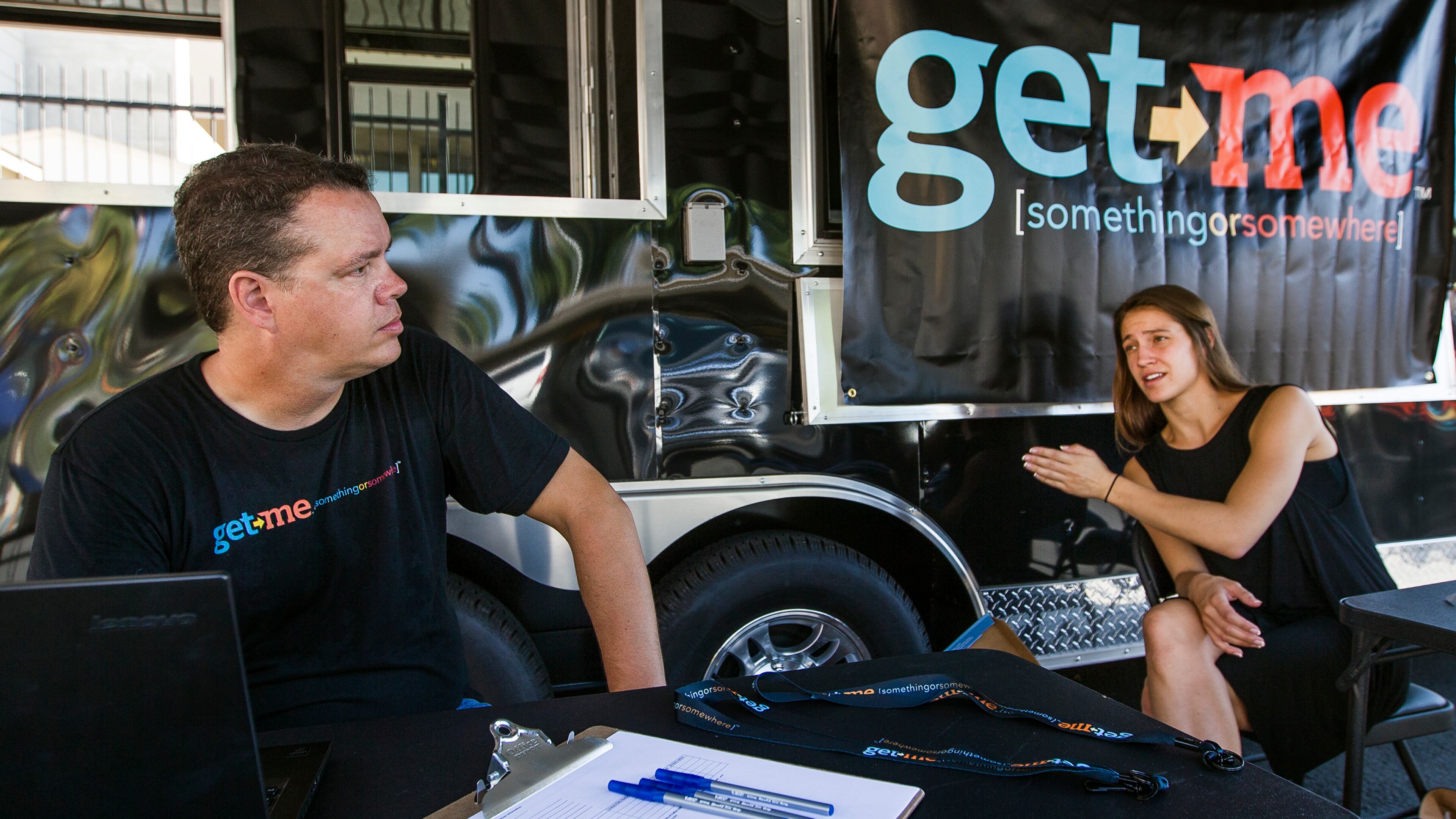 Get Me Rides & Deliveries employees Mark Amans, left, and Megan Monk sets up their sign up station outside of Aussie's restaurant on Barton Springs Rd, in Austin on Wednesday, Morning Sept. 23, 2015. Dallas-based Get Me is the latest app-based, on-demand ride and Delivery Company to launch in Austin, Texas. (RICARDO B. BRAZZIELL / AMERICAN-STATESMAN)
