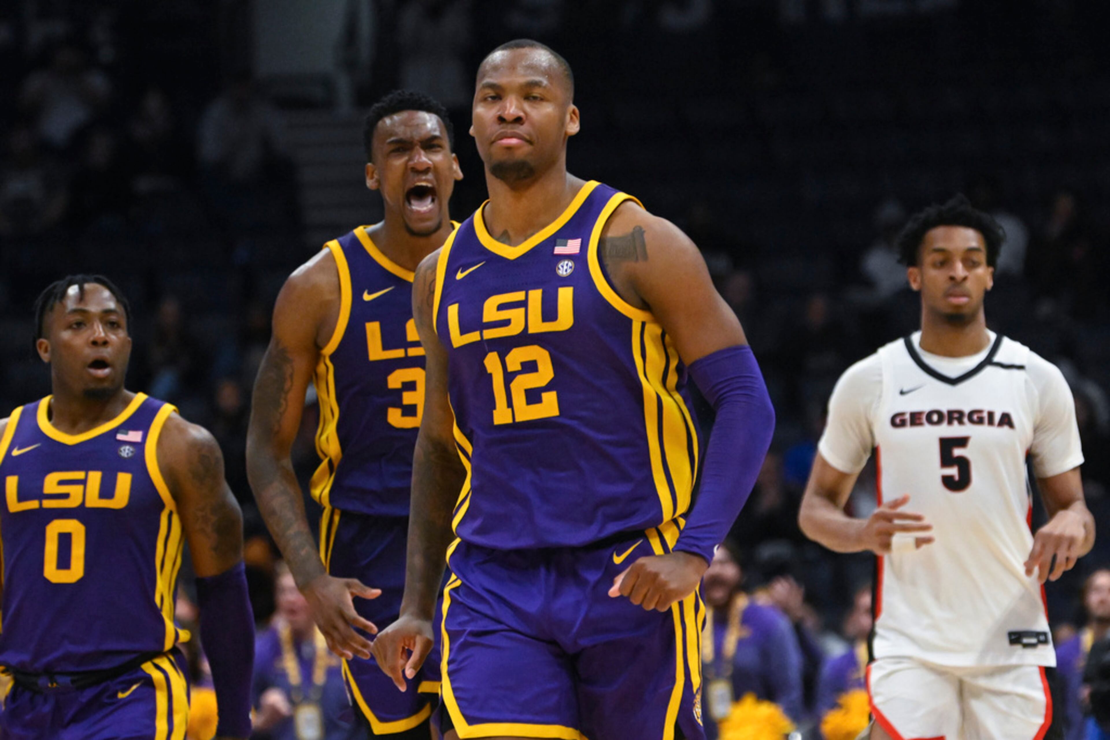 LSU forward KJ Williams (12) walks up court as forward Shawn Phillips celebrates behind him after scoring against Georgia in the final moments of an NCAA college basketball game in the first round of the Southeastern Conference tournament, Wednesday, March 8, 2023, in Nashville, Tenn. LSU won 72-67. (AP Photo/John Amis)
