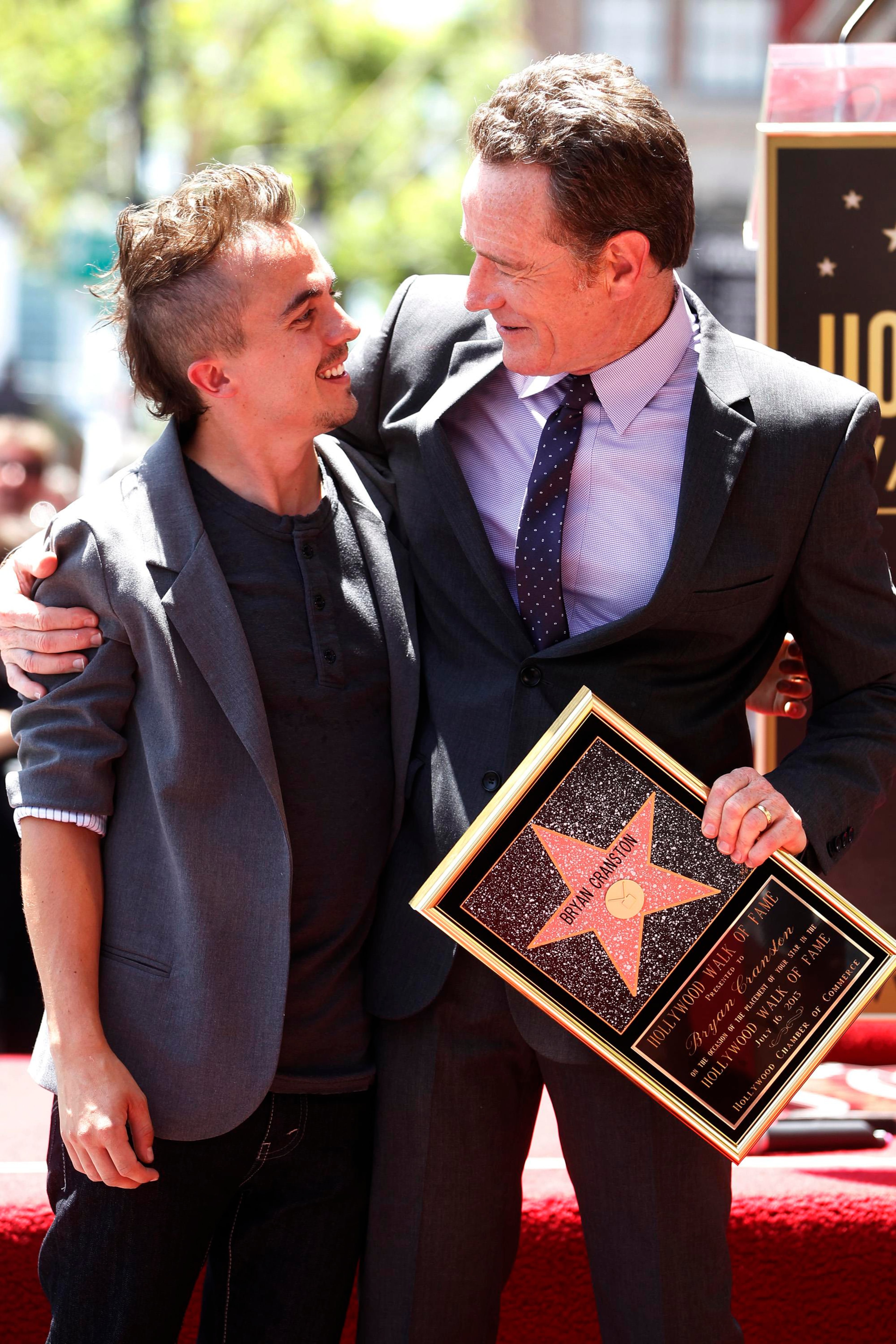 Actor Bryan Cranston poses with actor Frankie Muniz (L) during ceremonies unveiling his star on the Hollywood Walk of Fame in Hollywood July 16, 2013. Cranston and Muniz starred in the comedy series "Malcolm in the Middle" and Cranston currently stars in the AMC drama series "Breaking Bad."