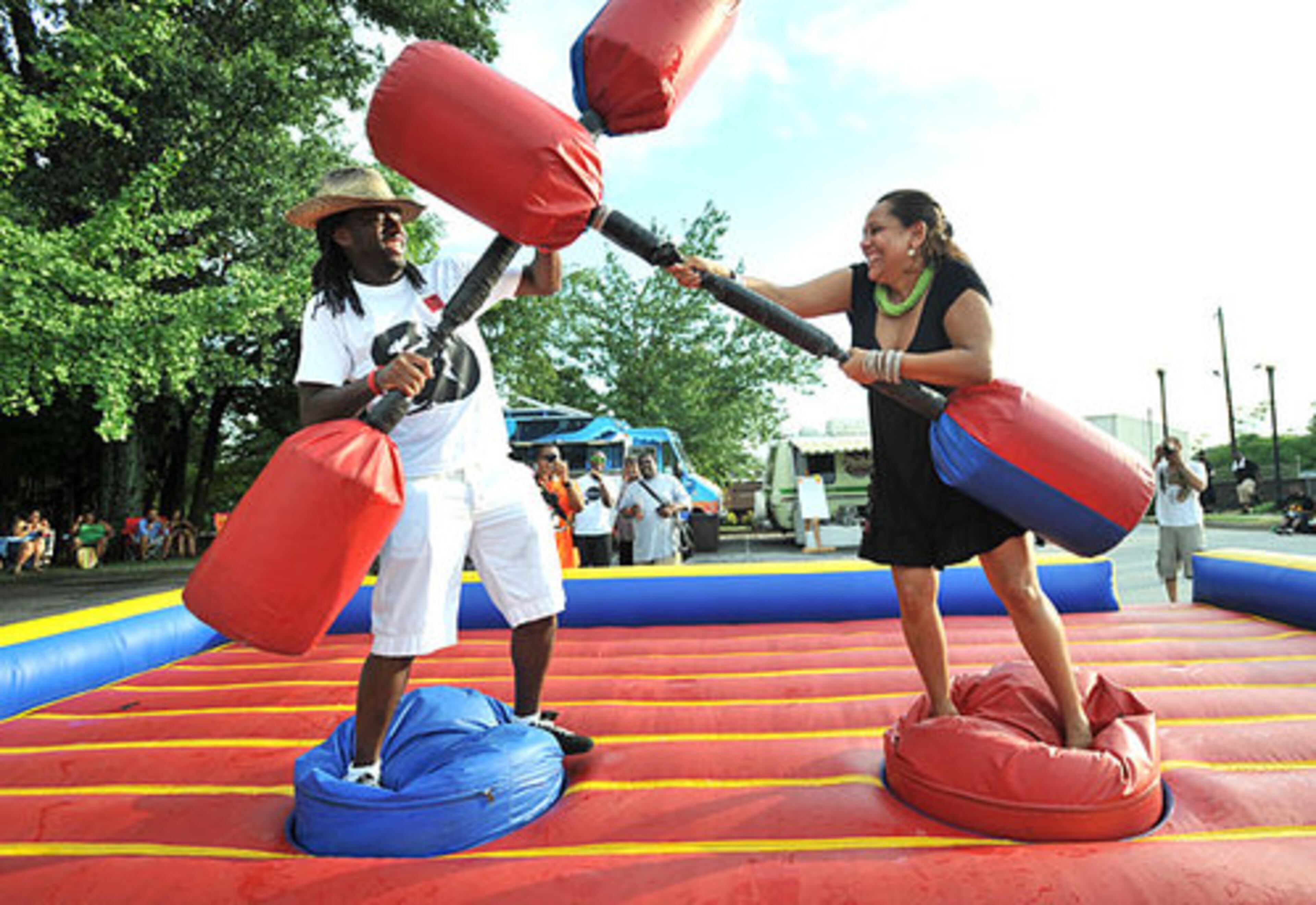 AJ Theaspot (left) and Denise Ransom, both of Atlanta, play inflatable jousting fight.