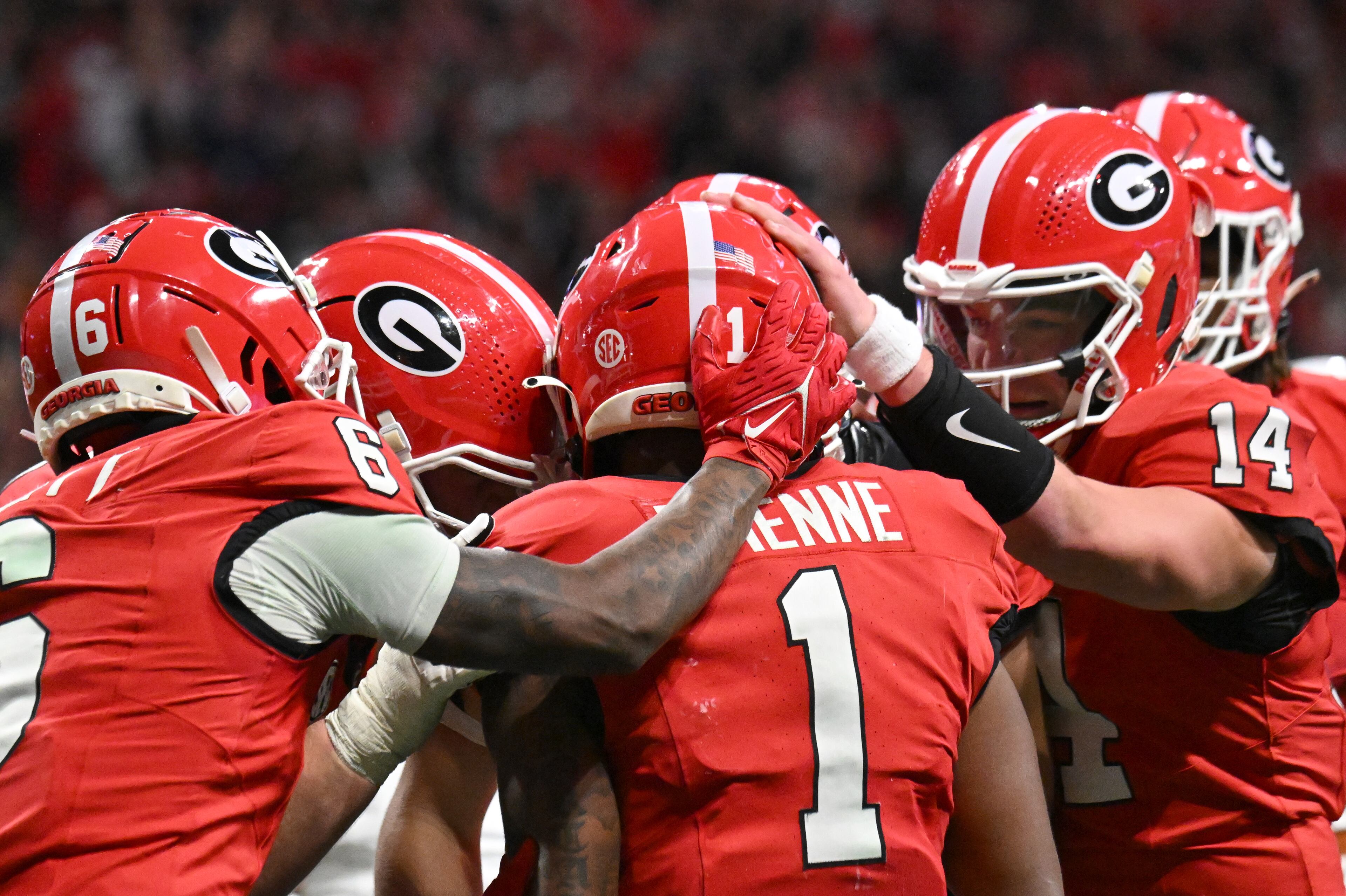 Georgia running back Trevor Etienne (1) celebrates with teammates after scoring a touchdown during the second half in the SEC Championship football game at the Mercedes-Benz Stadium, Saturday, December 7, 2024, in Atlanta. Georgia won 22-19 over Texas in overtime. (Hyosub Shin / AJC)