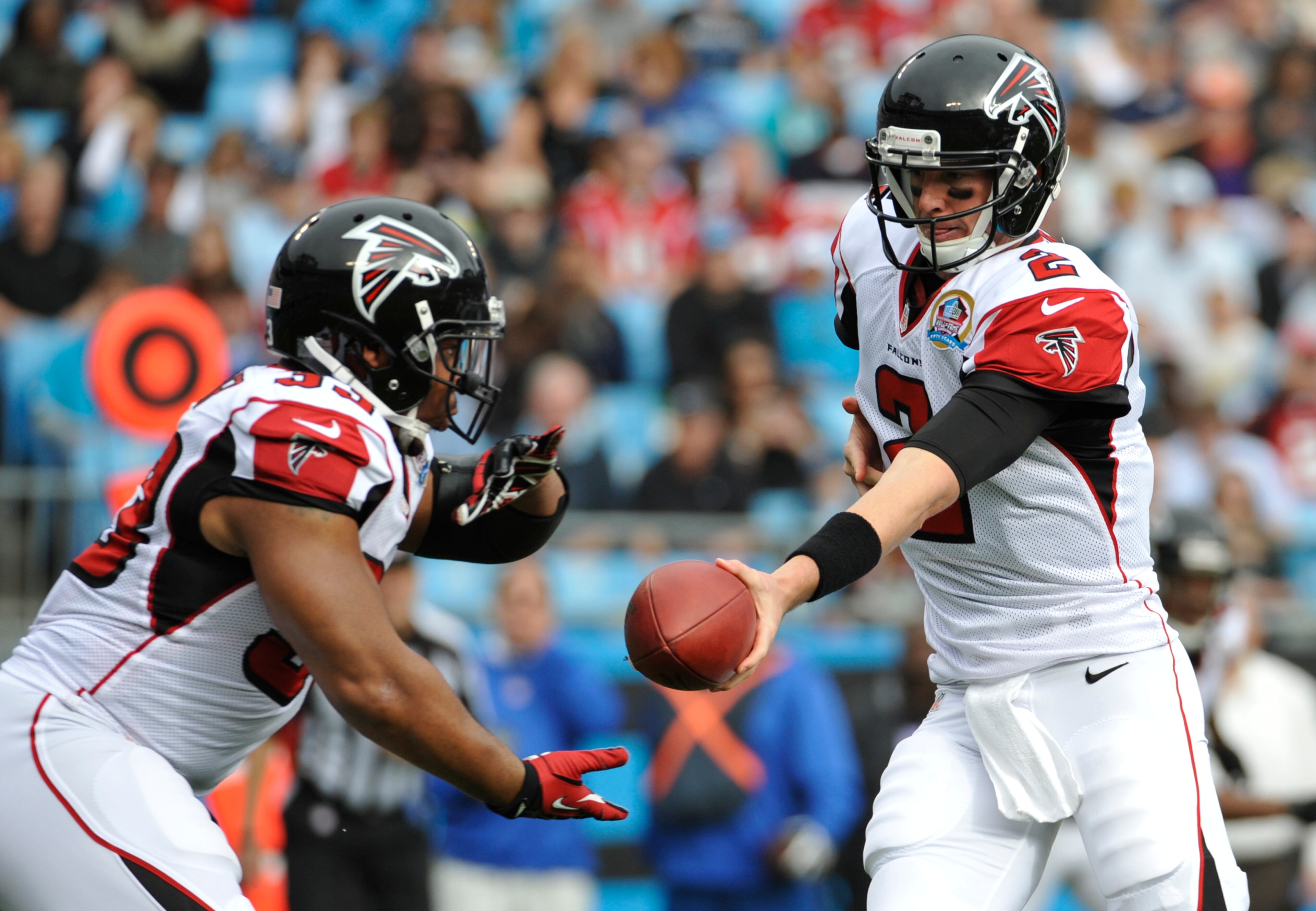 Atlanta Falcons' Matt Ryan (2) hands the ball off to Michael Turner (33) during the first half of an NFL football game against the Carolina Panthers in Charlotte, N.C., Sunday, Dec. 9, 2012. (AP Photo/Rainier Ehrhardt)