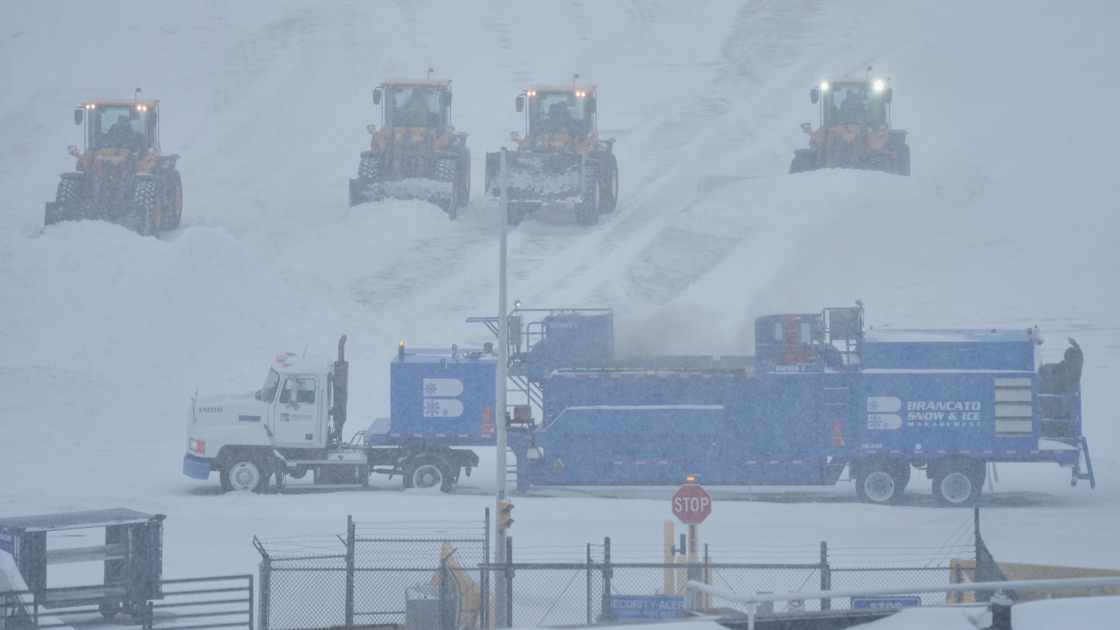 Airport crew plow snow during a winter storm in Philadelphia, Sunday, Jan. 25, 2026. (AP Photo/Matt Rourke)