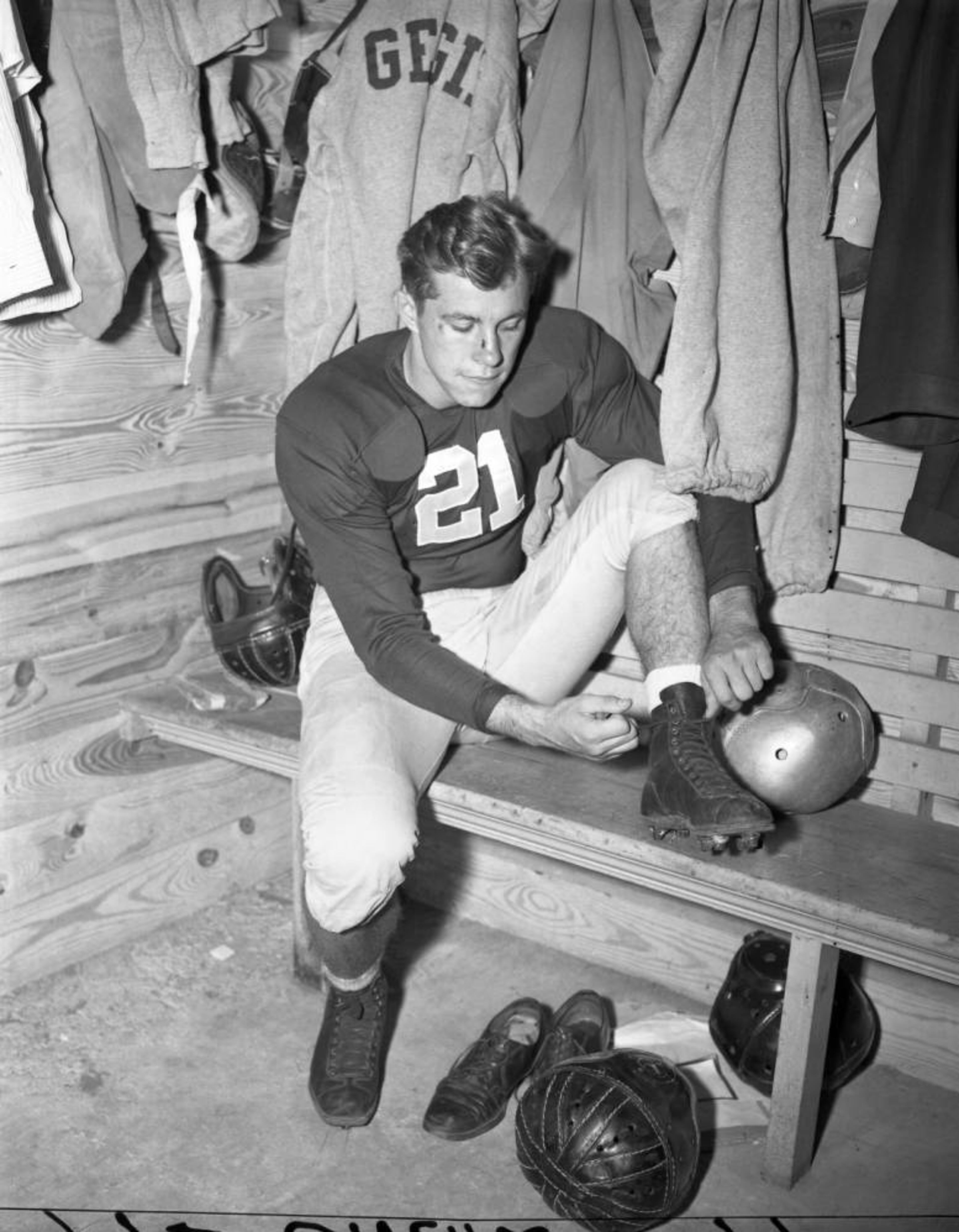 Georgia Bulldogs' Frank Sinkwich in the locker room getting ready in 1942. That same year, the University of Georgia player would win the Heisman Trophy. He was inducted into the College Football Hall of Fame in 1954. AJCN001-073c, Atlanta Journal-Constitution Photographic Archives. Special Collections and Archives, Georgia State University Library.