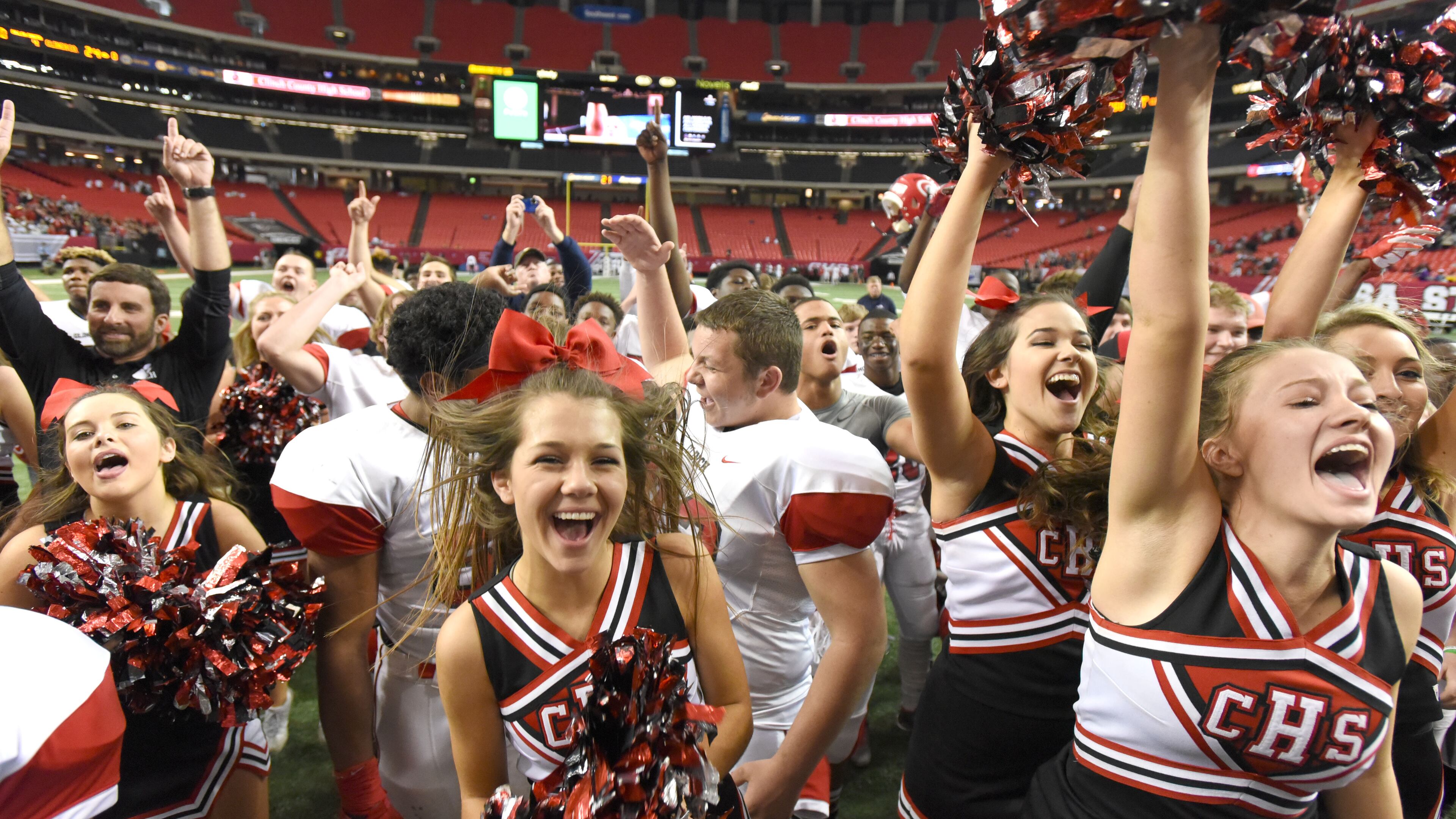 December 11, 2015 Atlanta - Clinch County cheerleaders and player celebrate during Clinch County's 24 - 7 win over Irwin County in the GHSA Class A- Public State Championship at the Georgia Dome on Friday December 11, 2015. HYOSUB SHIN / HSHIN@AJC.COM
