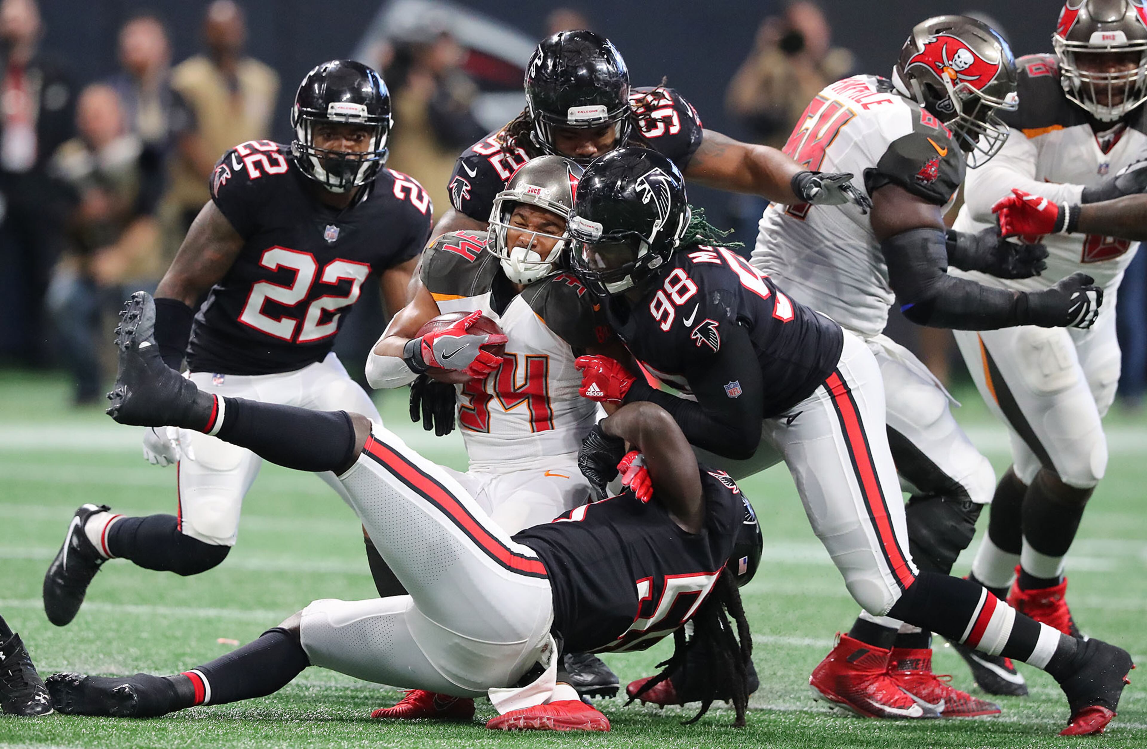 November 26, 2017 Atlanta: Falcons defenders Takkarist McKinley and Deââ¬â¢Vondre Campbell level Buccaneers running back Charles Sims III during the second half in a NFL football game on Sunday, November 26, 2017, in Atlanta. Curtis Compton/ccompton@ajc.com