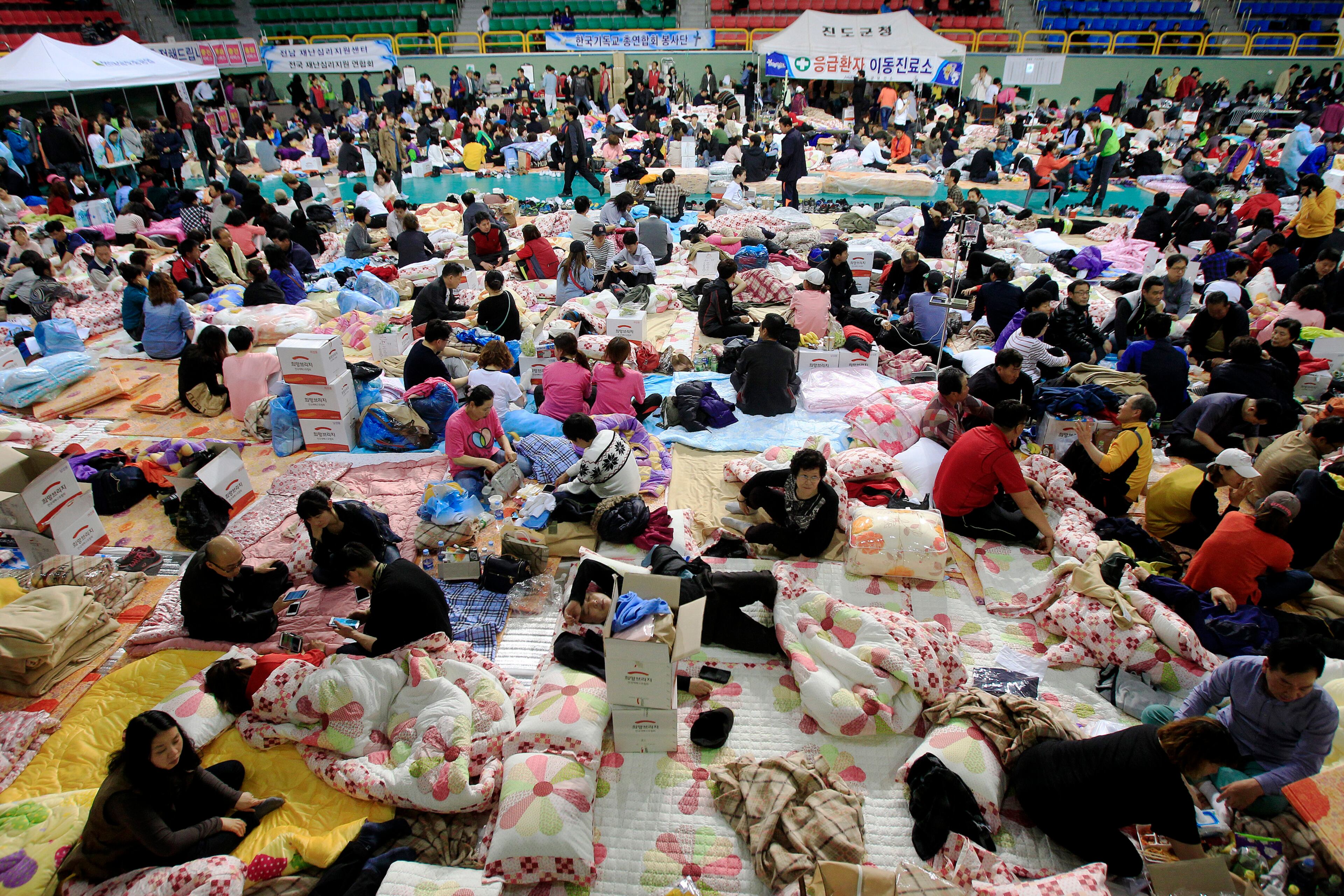 Family members of children are still missing in the sunken ferry the Sewol gather at a gymnasium in Jindo, South Korea, Thursday, April 17, 2014. (AP Photo/Ahn Young-joon)