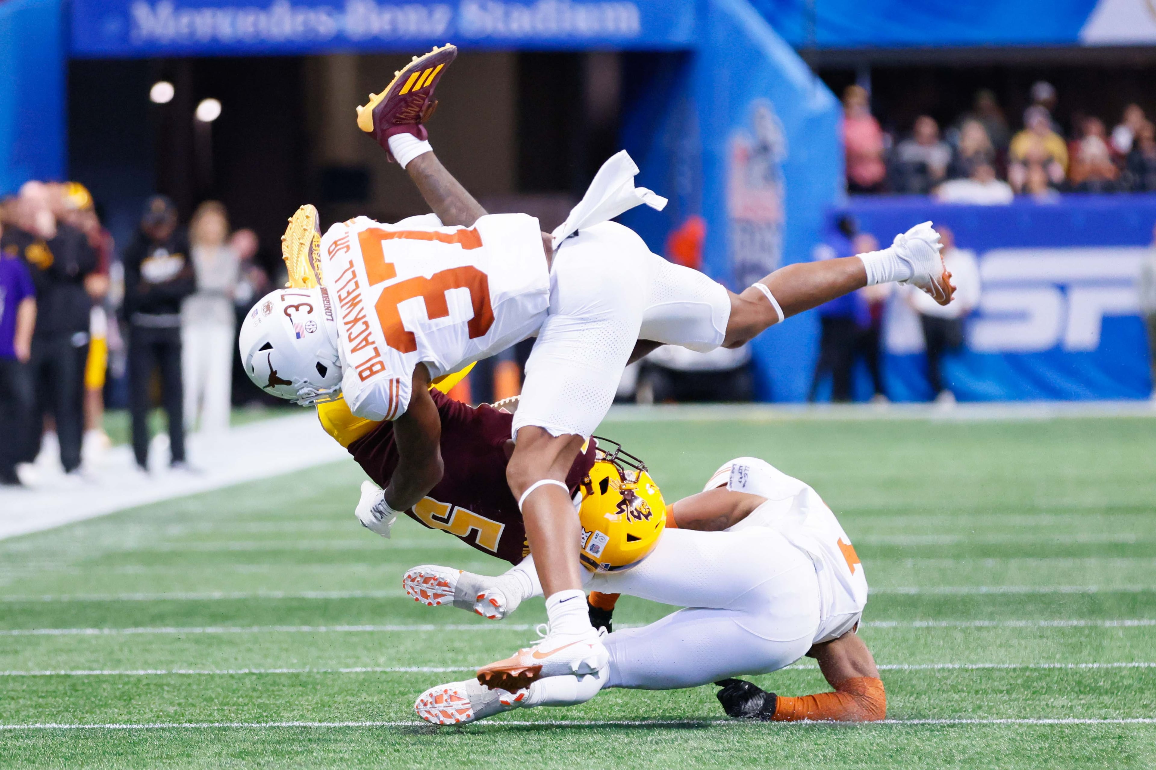 Arizona State Sun Devils wide receiver Melquan Stovall (5) took a hard hit from Texas Longhorns linebacker Morice Blackwell Jr. (37) during the first half in the 2024 Chick-fil-A Peach Bowl at Mercedes-Benz Stadium, Wednesday, January 1, 2025, in Atlanta.
(Miguel Martinez / AJC)