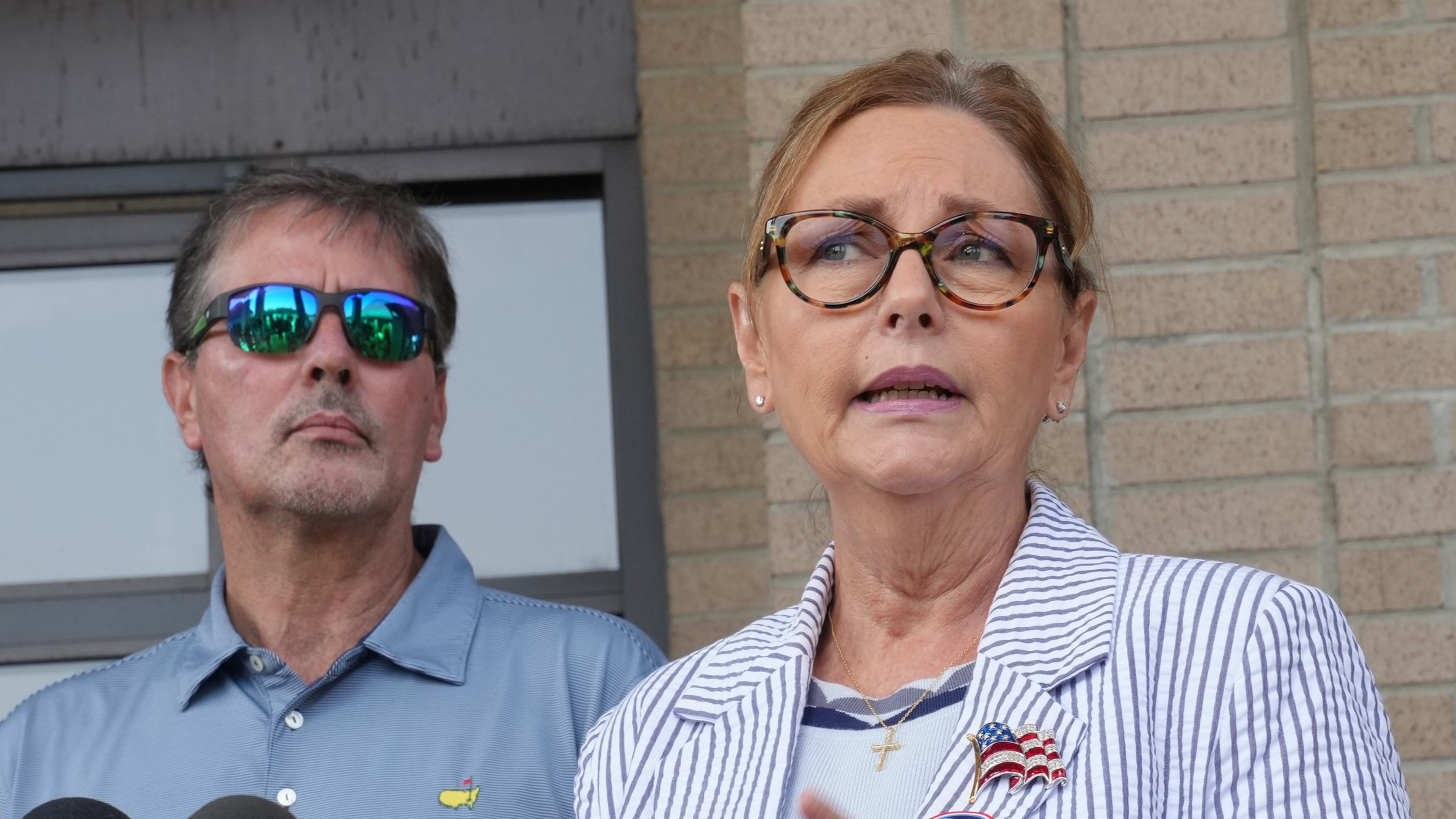 Larry Nordone looks on as his wife, U.S. Sen. Darline Graham, R-S.C., speaks to reporters after she voted in a special Republican primary to replace her brother, U.S. Sen. Lindsey Graham, R-S.C., on November ballots on Tuesday, Aug. 11, 2026, in Florence, S.C. (AP Photo/Meg Kinnard)