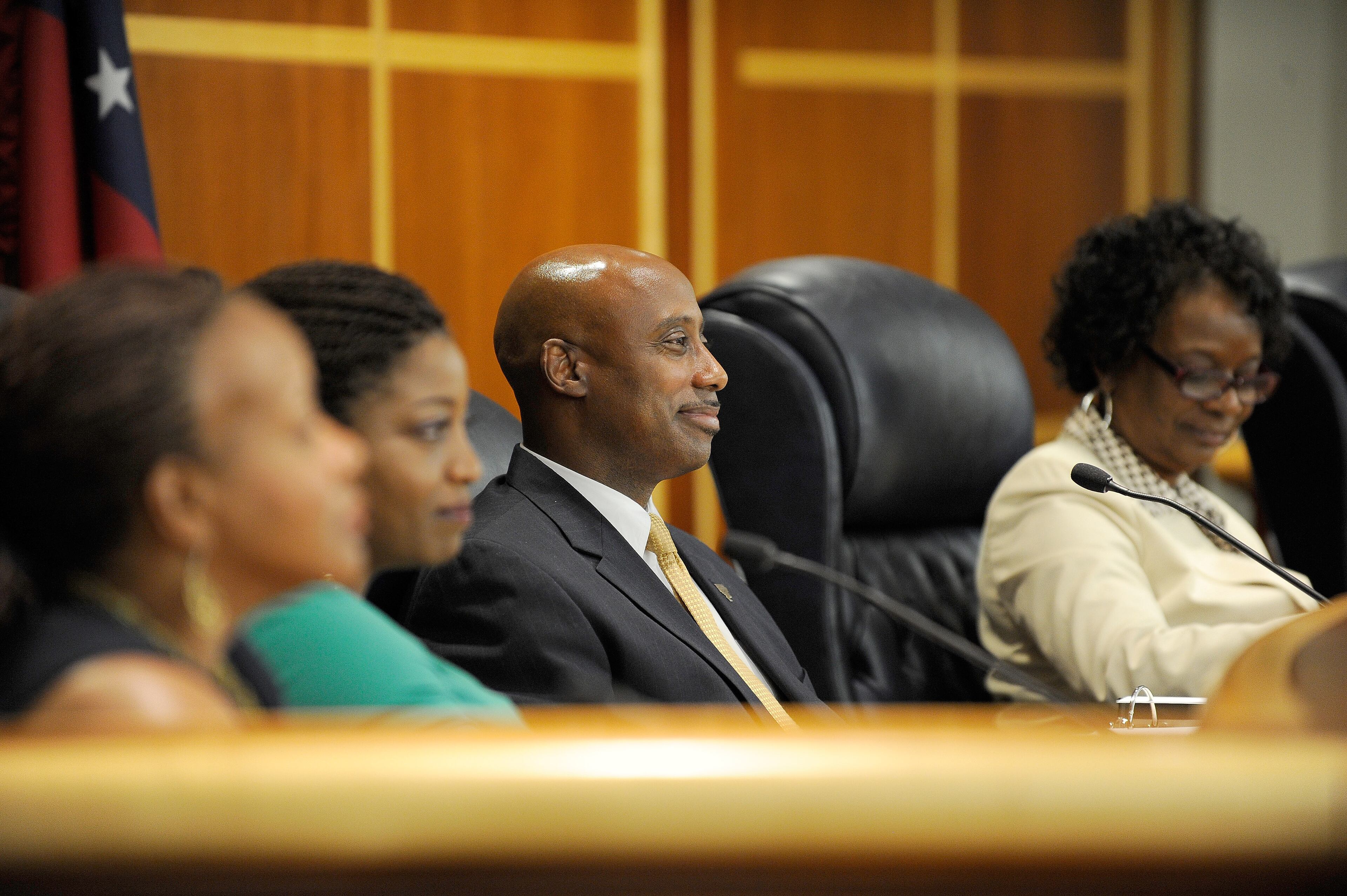 Clayton County Board of Commissioners Chairman Jeff Turner (C) listens with other commissioners as members of a standing-room-only crowd present views for and against a referendum to join MARTA for the November ballot during a commission meeting Tuesday, July 1, 2014, in Jonesboro, Ga. If approved by voters, the transportation measure would usher in the first additional county since the inception of the transit authority. David Tulis / AJC Special