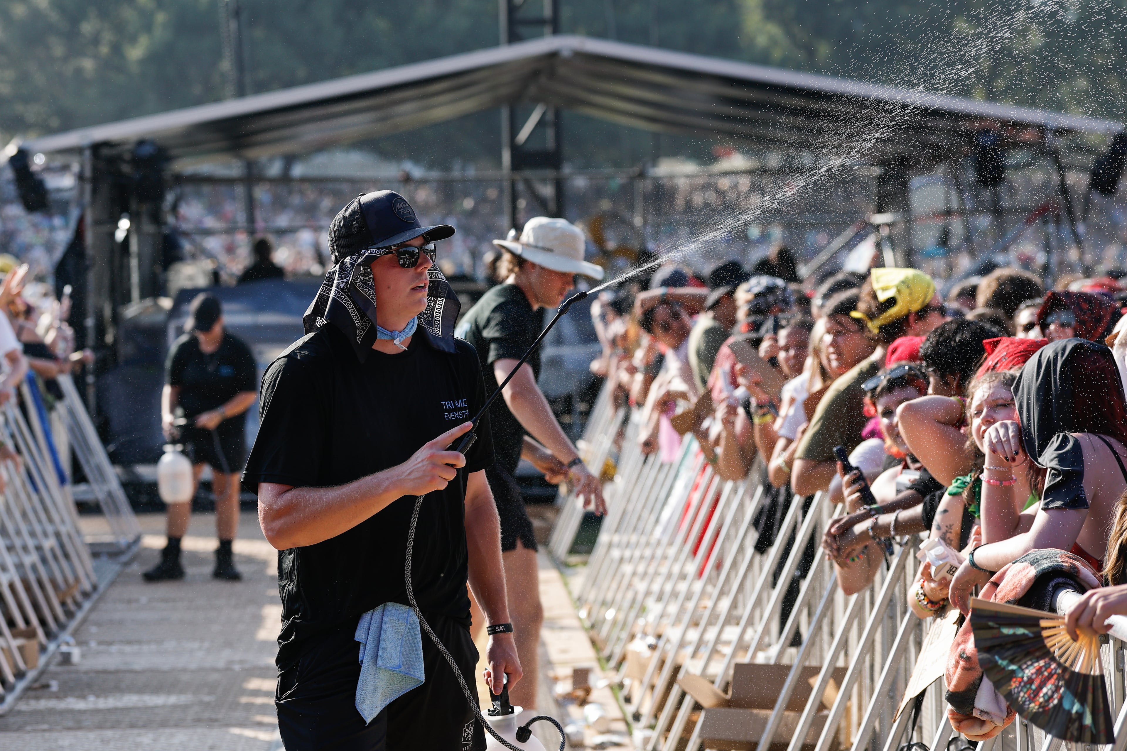 Fans try to keep cool as Peach Pit performs during the Shaky Knees music festival at Piedmont Park, Saturday, Sept. 19, 2026, in Atlanta. (Erik S. Lesser for the AJC)