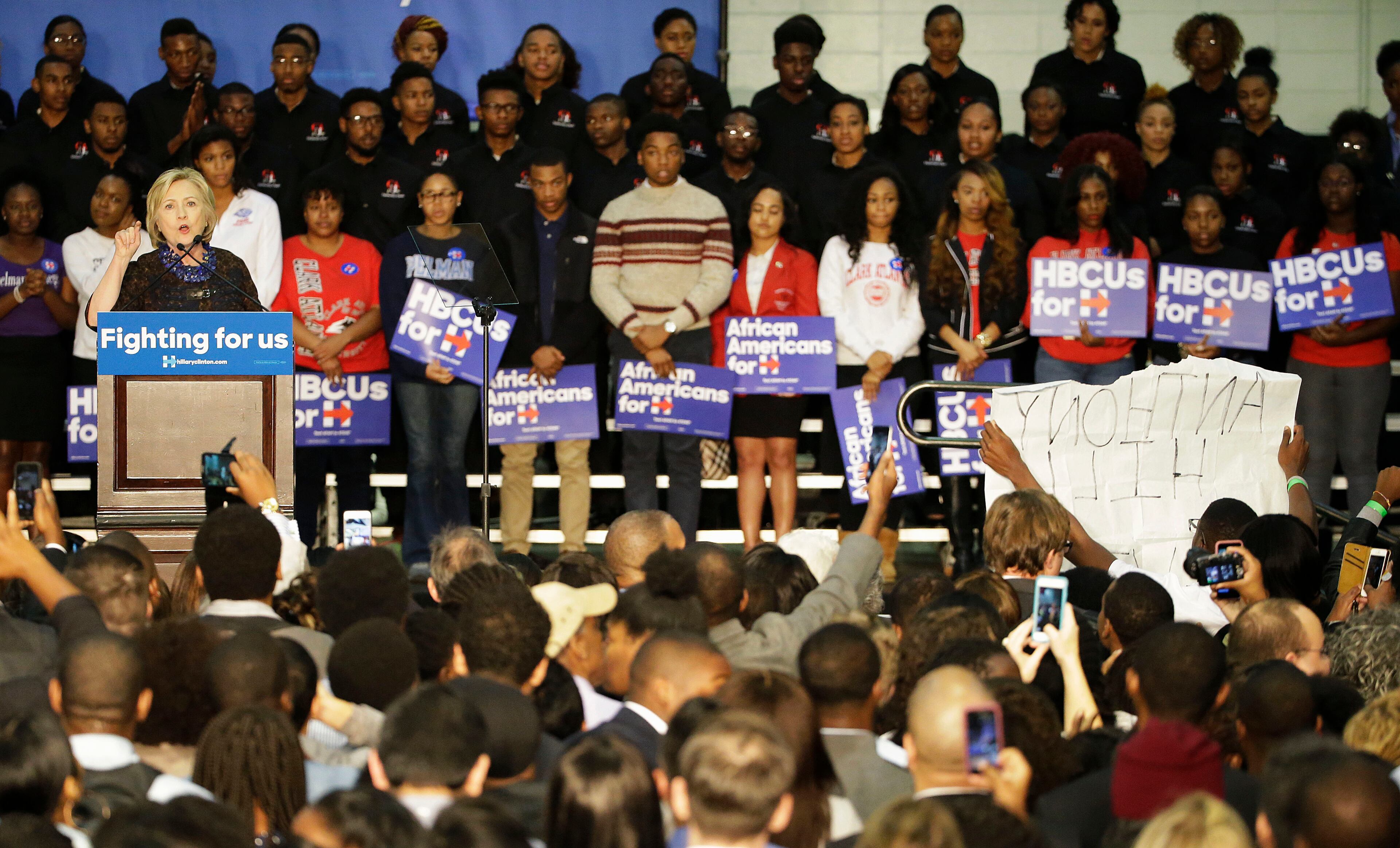 Protesters at right interrupt Democratic presidential candidate Hillary Rodham Clinton as she speaks during a campaign event at Clark Atlanta in Atlanta, University Friday, Oct. 30, 2015. (AP Photo/David Goldman)
