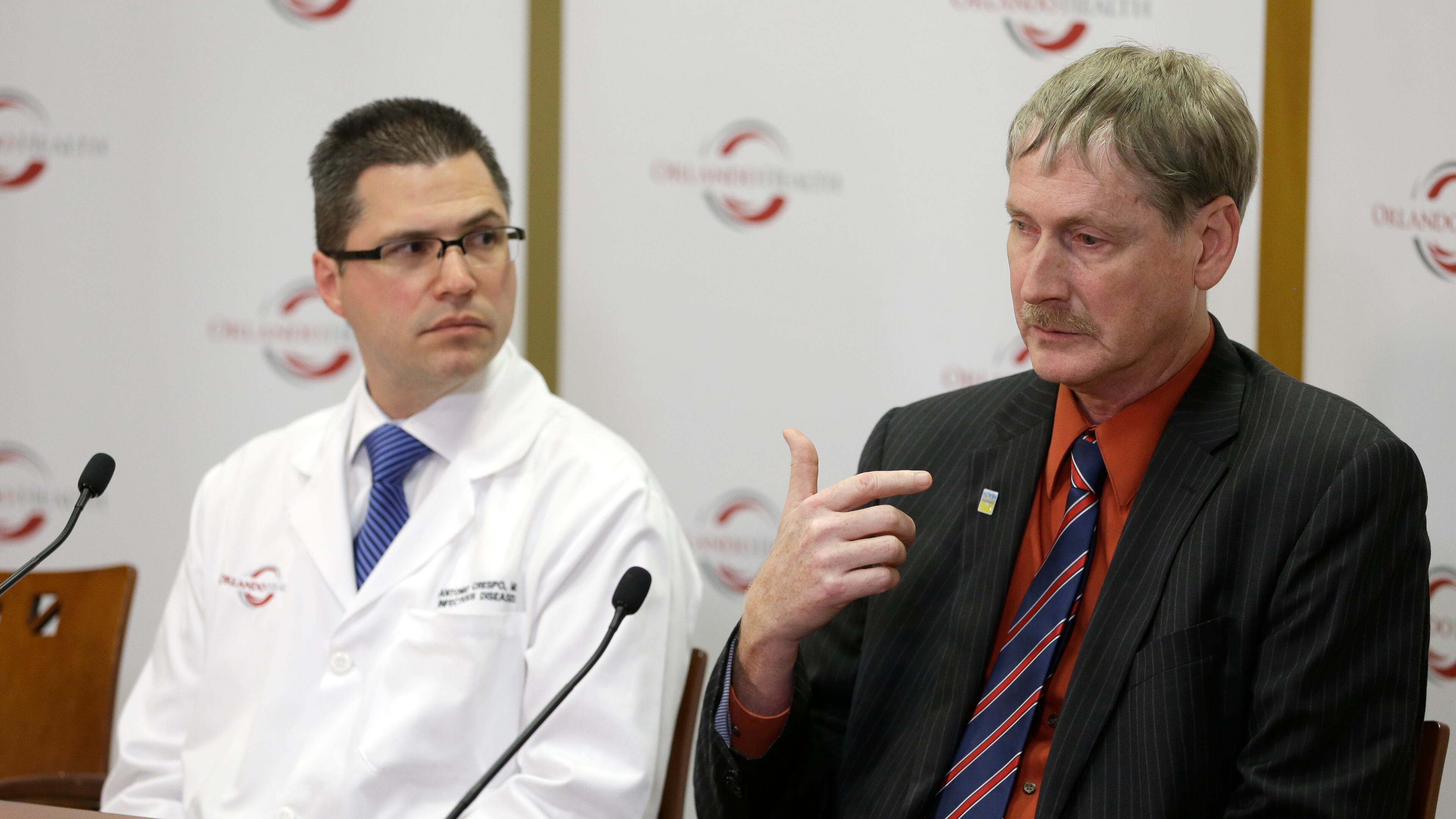 Dr. Kevin Sherin, MD, right, the health officer for the Florida Department of Health in Orange County speaks as Dr. Antonio Crespo, MD, left, the Chief Quality officer at Dr. P. Phillips Hospital listens, at a news conference to provide an update on the first MERS, or Middle East Respiratory Syndrome case in Fla., Tuesday, May 13, 2014, in Orlando, Fla. Fifteen hospital workers at Dr. Phillip Hospital and another five employees at Orlando Regional Medical Center were being monitored at home for fever, chills and muscle aches, said Crespo. So far, none of them have tested positive for MERS, or Middle East Respiratory Syndrome.