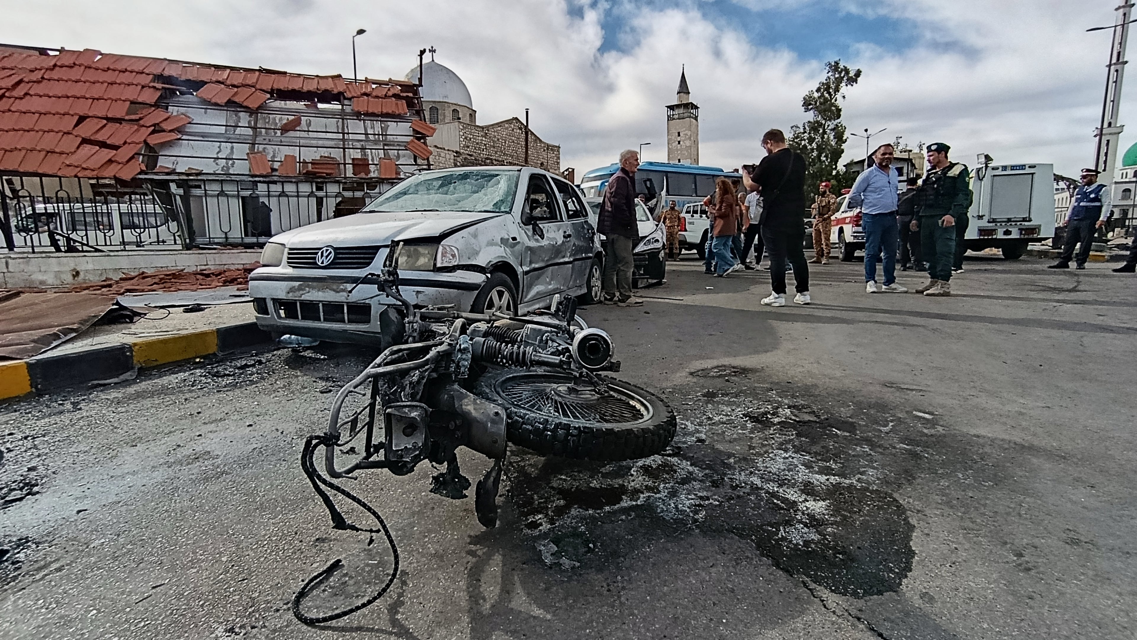 Syrian security personnel inspect the site of an explosion outside a Defense Ministry building in Damascus, Syria, Tuesday, May 19, 2026. (AP Photo/Abdulrahman Shaheen)