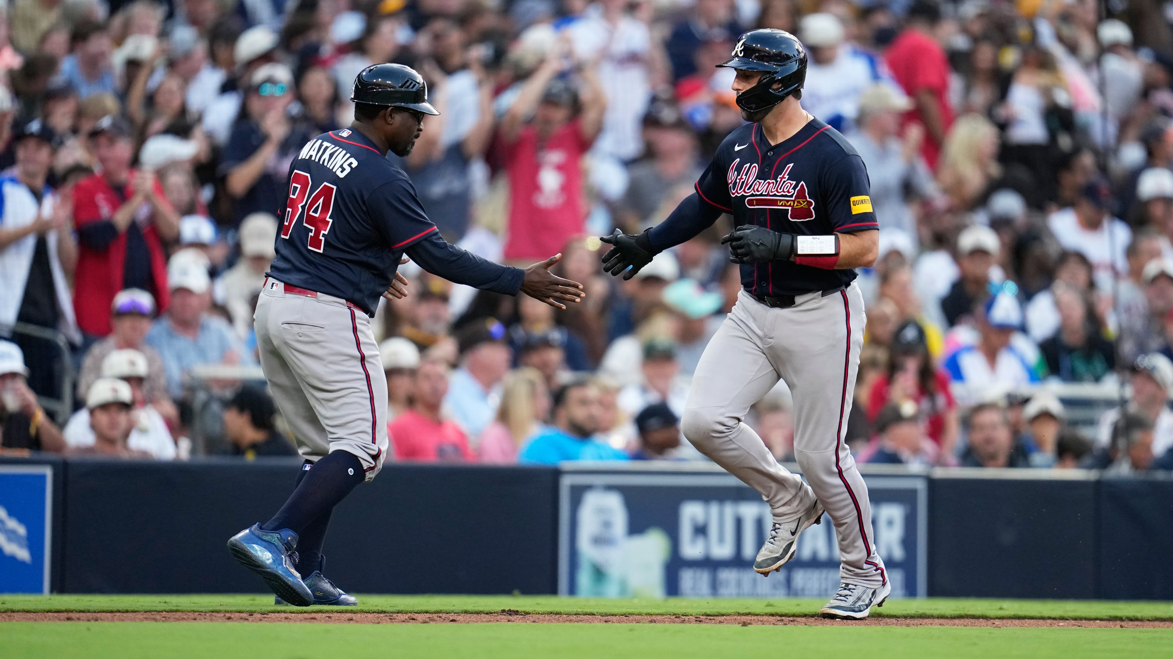 Atlanta Braves' Joey Bart (right) celebrates with third base coach Tommy Watkins after hitting a two-run home run during the sixth inning of a baseball game against the San Diego Padres Wednesday, June 24, 2026, in San Diego. (Gregory Bull/AP)