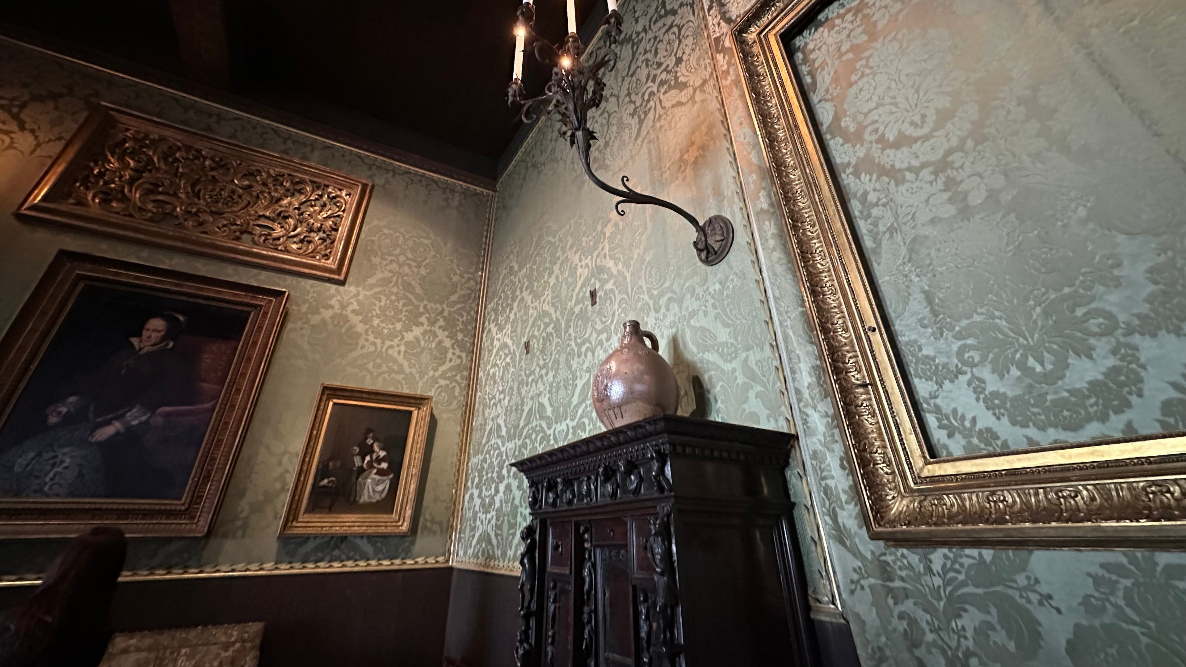 An empty frame hangs on patterned green walls in the Dutch Room at the Isabella Stewart Gardner Museum, where artworks were stolen in a 1990 art heist, April 9, 2026, in Boston. (AP Photo/Leah Willingham)