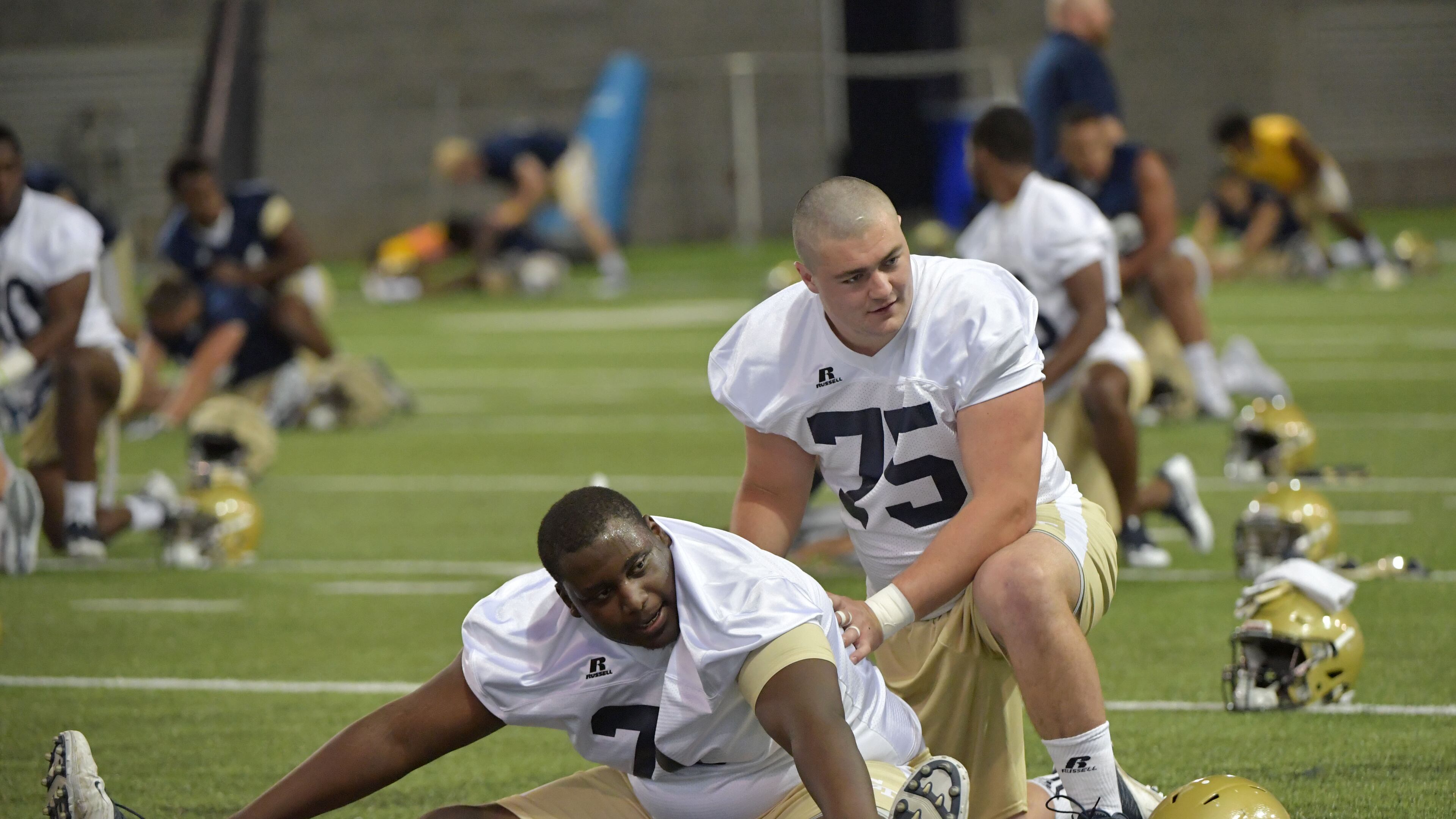 August 4, 2017 Atlanta - Georgia Tech offensive lineman Shamire Devine (71) and offensive lineman Parker Braun (75) warm up during the first day of Georgia Tech football practice at Rose Bowl Field in Georgia Tech campus on Friday, August 4, 2017. HYOSUB SHIN / HSHIN@AJC.COM