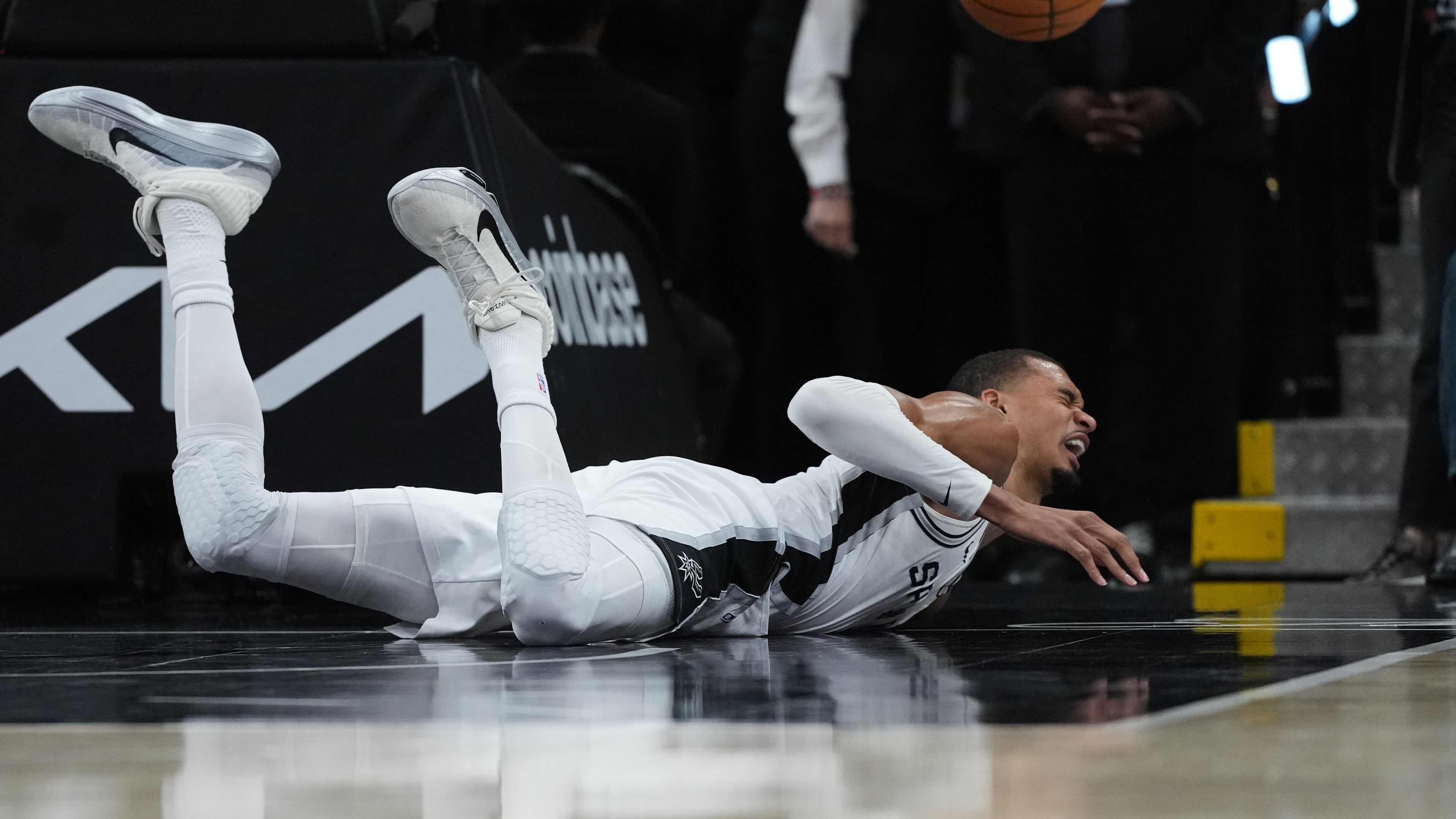 San Antonio Spurs forward Victor Wembanyama (1) takes a hard fall on the court during the first half in Game 2 of a first-round NBA playoffs basketball series against the Portland Trail Blazers in San Antonio, Tuesday, April 21, 2026. (AP Photo/Eric Gay)